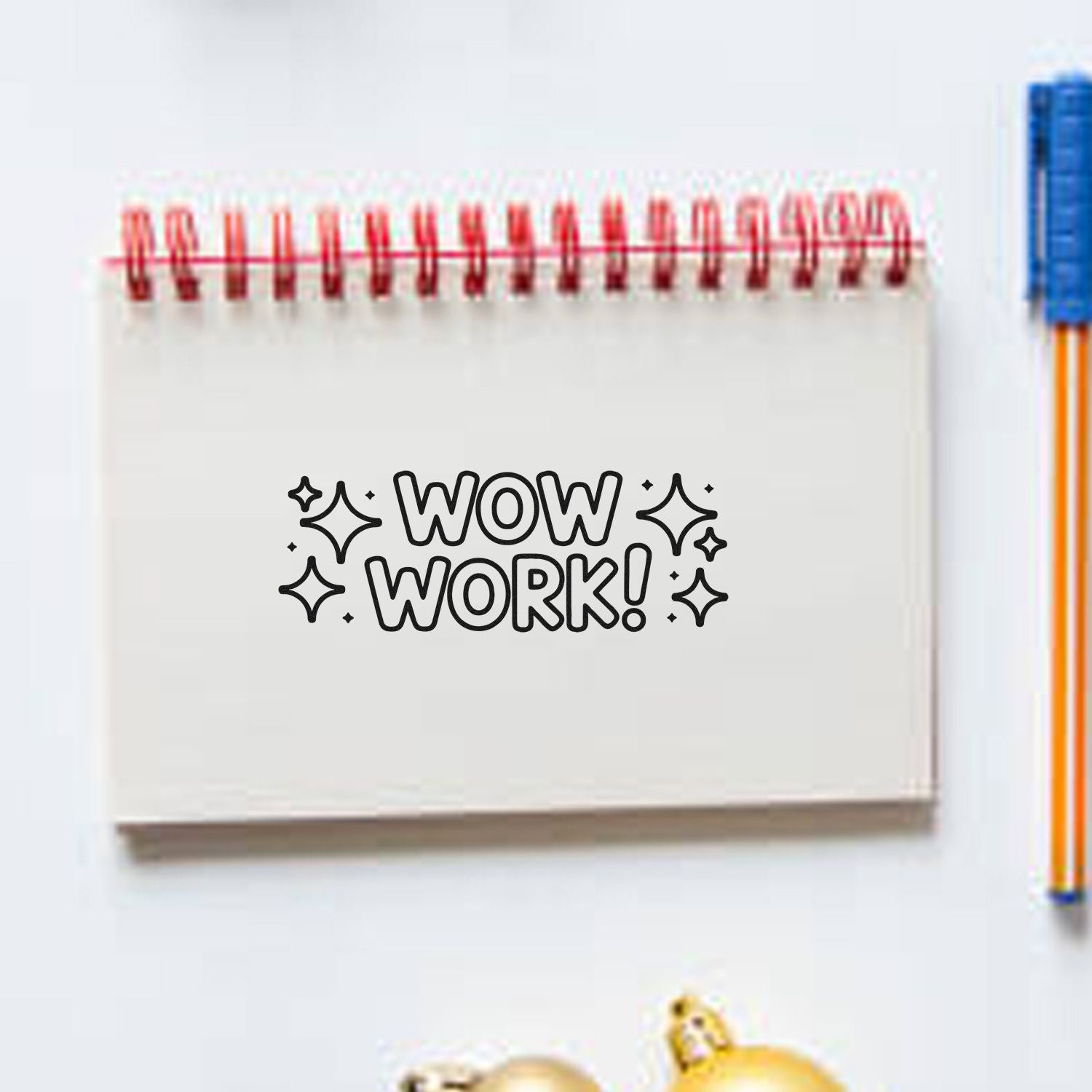 White spiral notebook stamp/seal with black WOW WORK! text, sparkle accents, and red spiral binding.