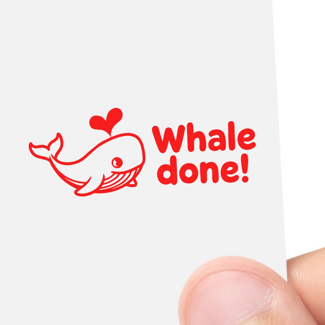 Red whale stamp and seal with heart fin and Whale done! text on a white card.