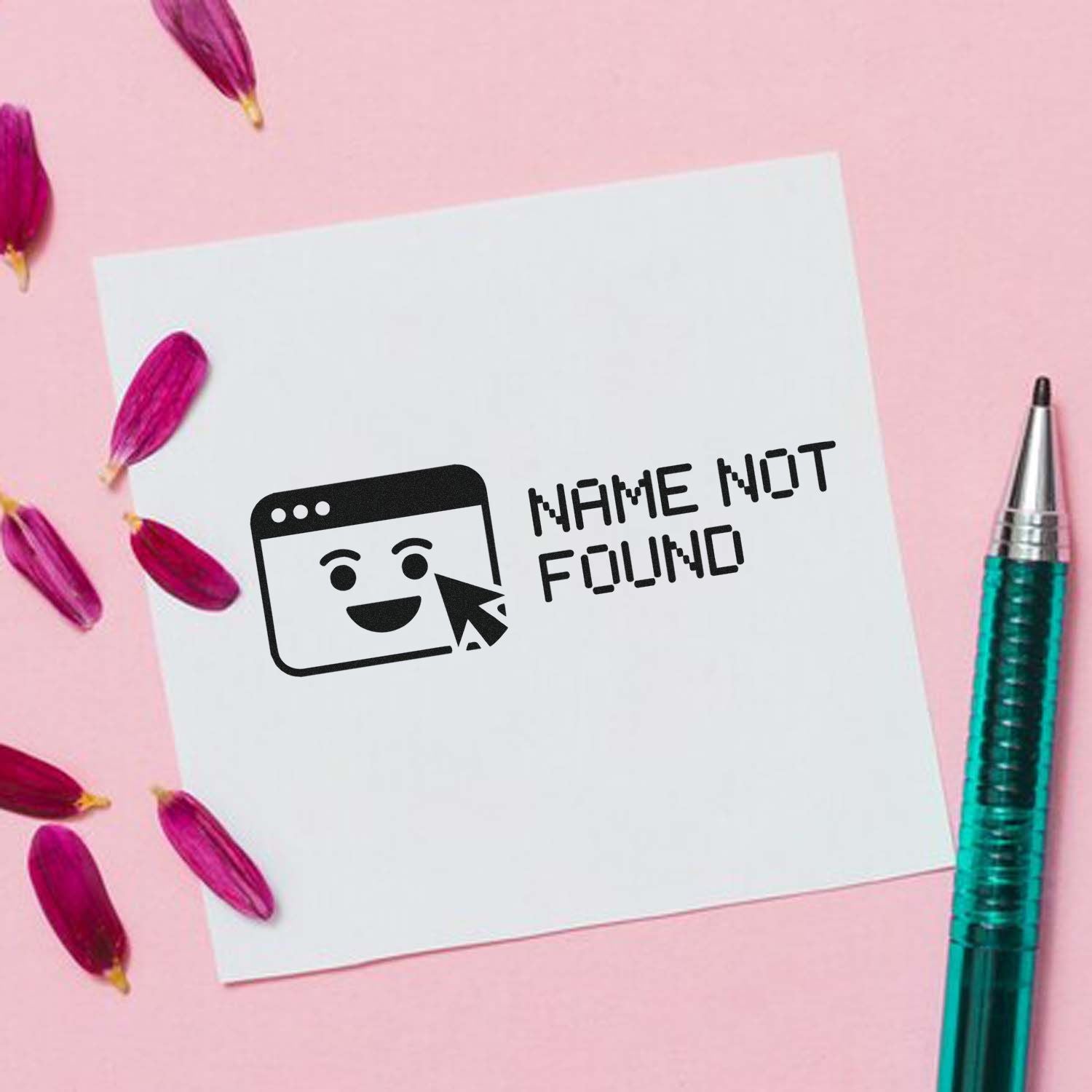 White stamp seal card with black NAME NOT FOUND graphic, smiley browser icon, on pink background with magenta petals and teal pen.
