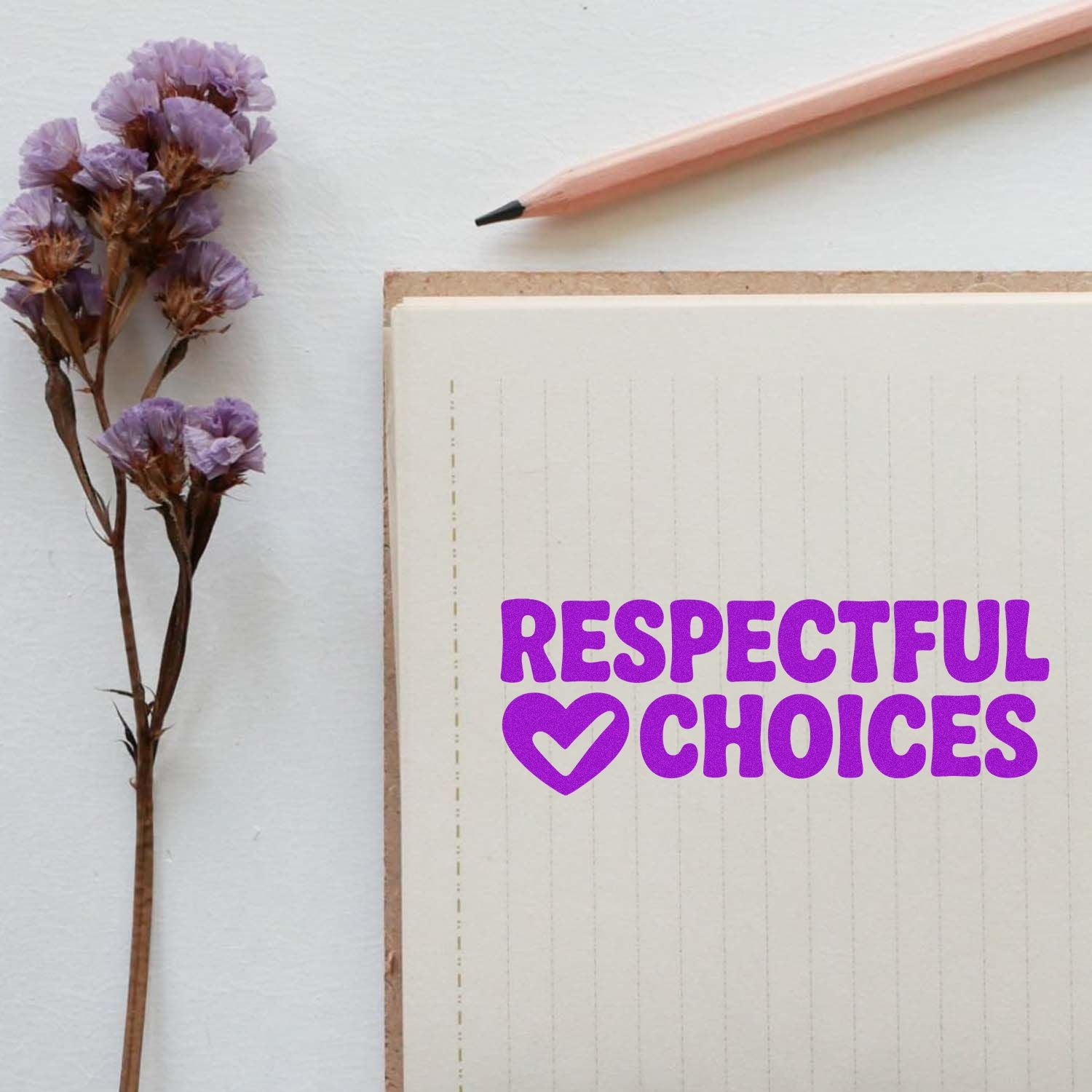 Purple Respectful Choices stamp seal with heart icon on cream notebook, beside dried lavender and a pink pencil.