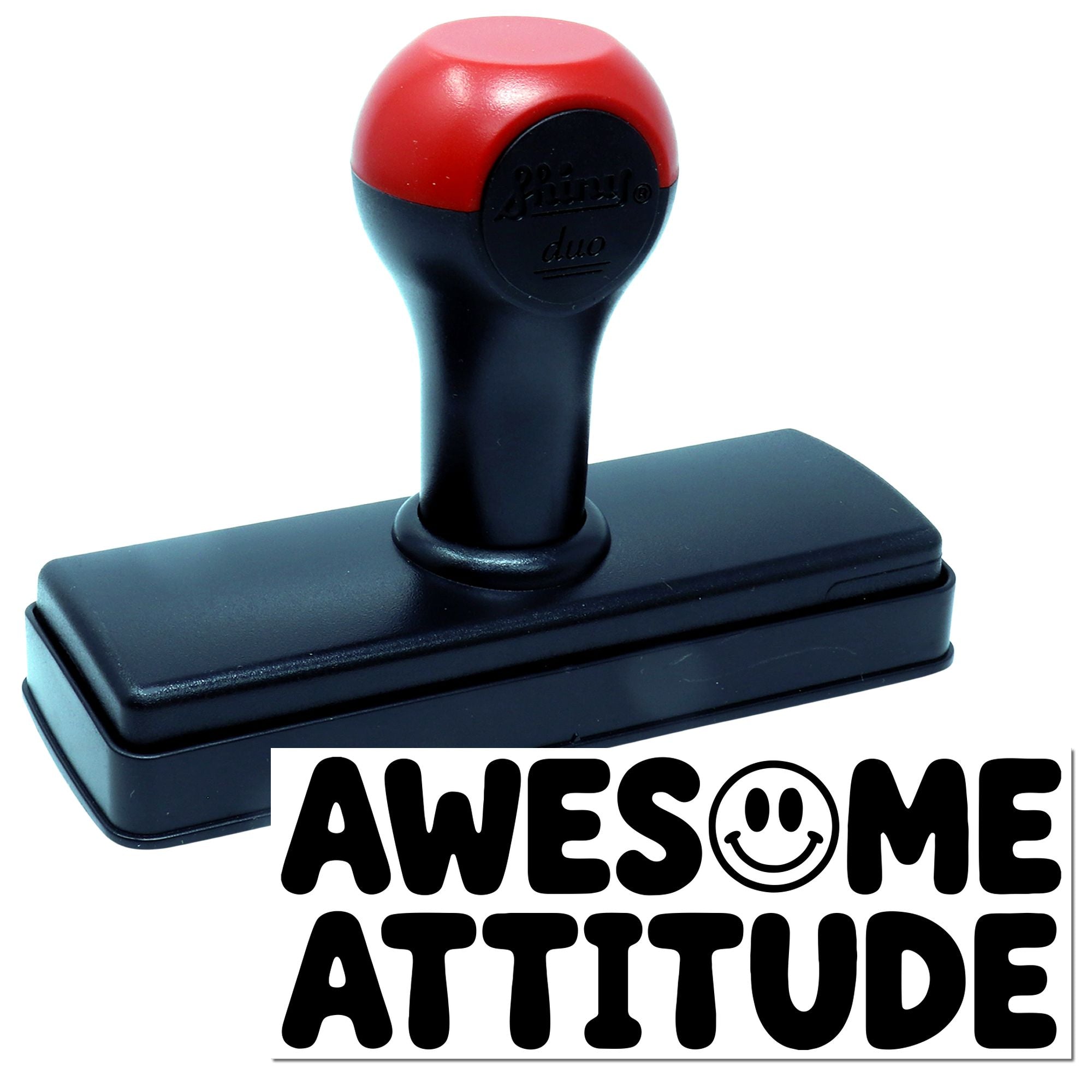 Red and black self-inking stamp and seal with rectangular base, showing AWESOME ATTITUDE imprint.