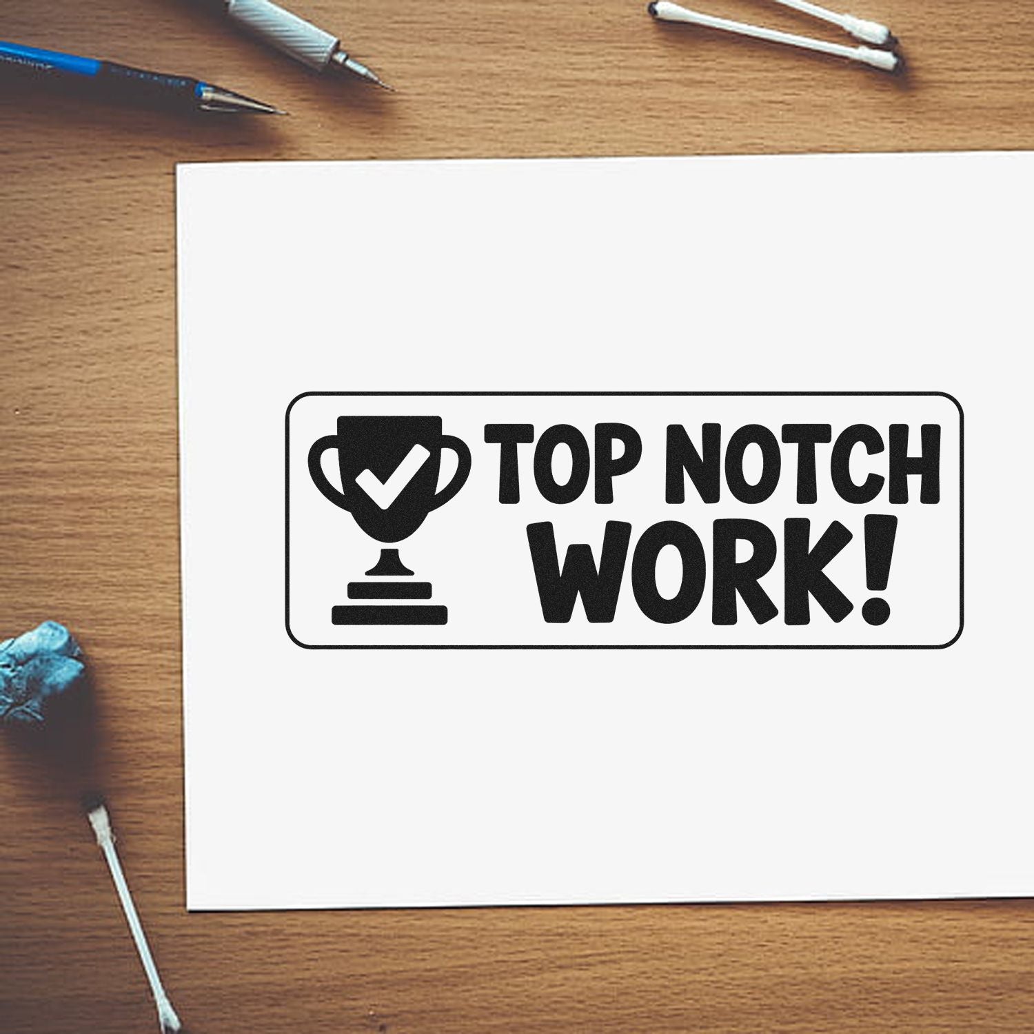 Black Top Notch Work! stamp and seal design with trophy checkmark on white paper, on a wood desk.