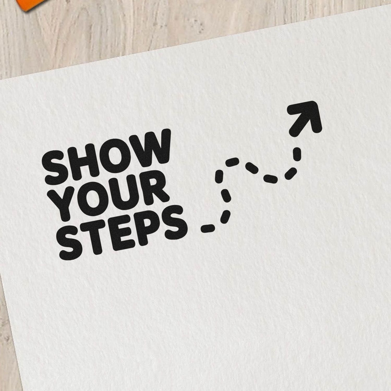 Black stamp imprint reading SHOW YOUR STEPS with a dotted arrow on white paper for seal and stamp products.