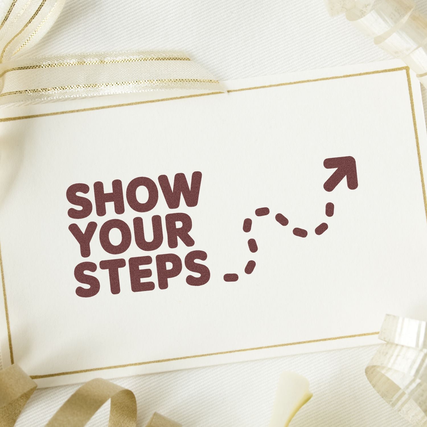 Maroon Show Your Steps stamp and seal on white card with gold border, dotted arrow, and sheer ivory ribbon.