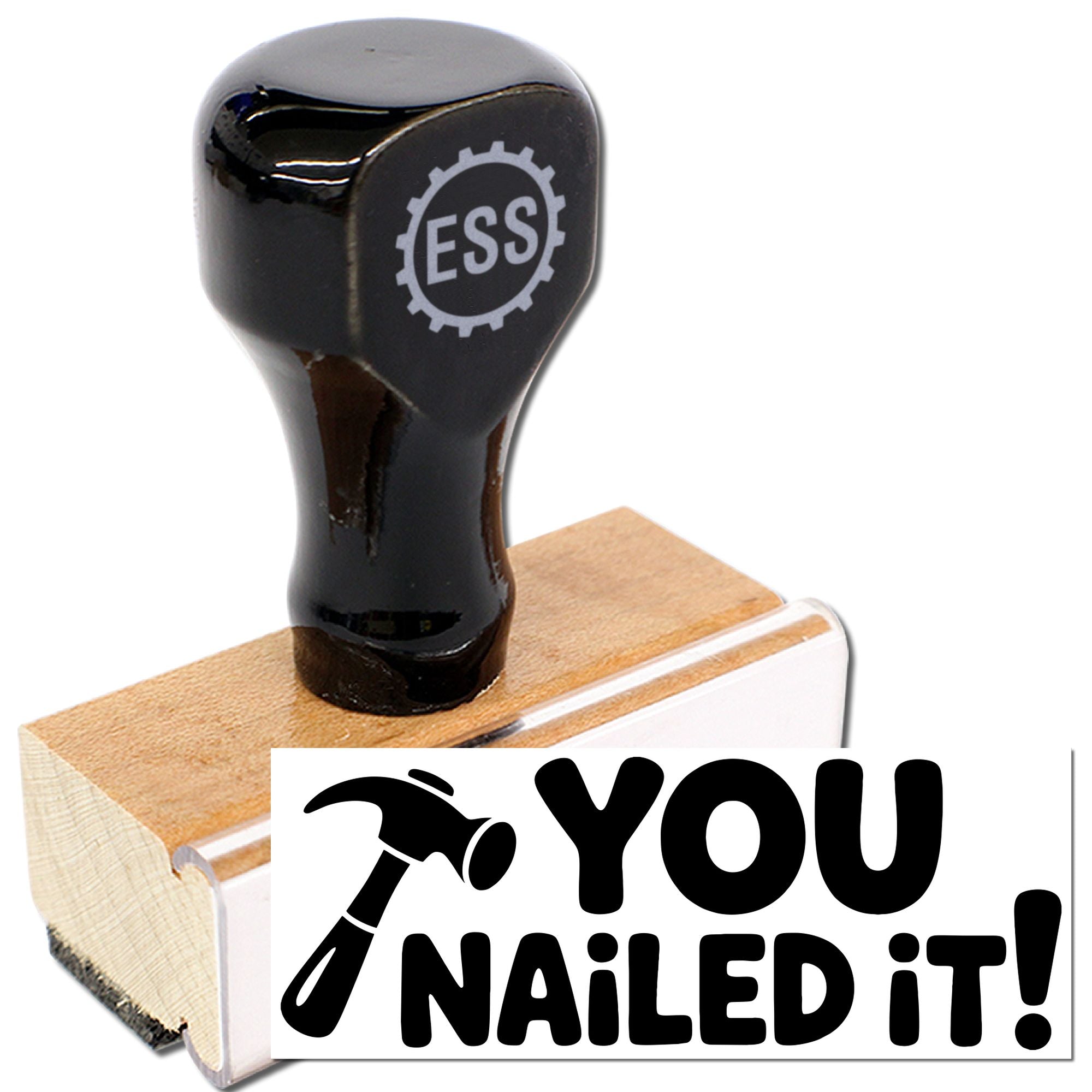 Black rubber stamp seal on a wooden block, with ESS logo and bold black You Nailed It! text on white.