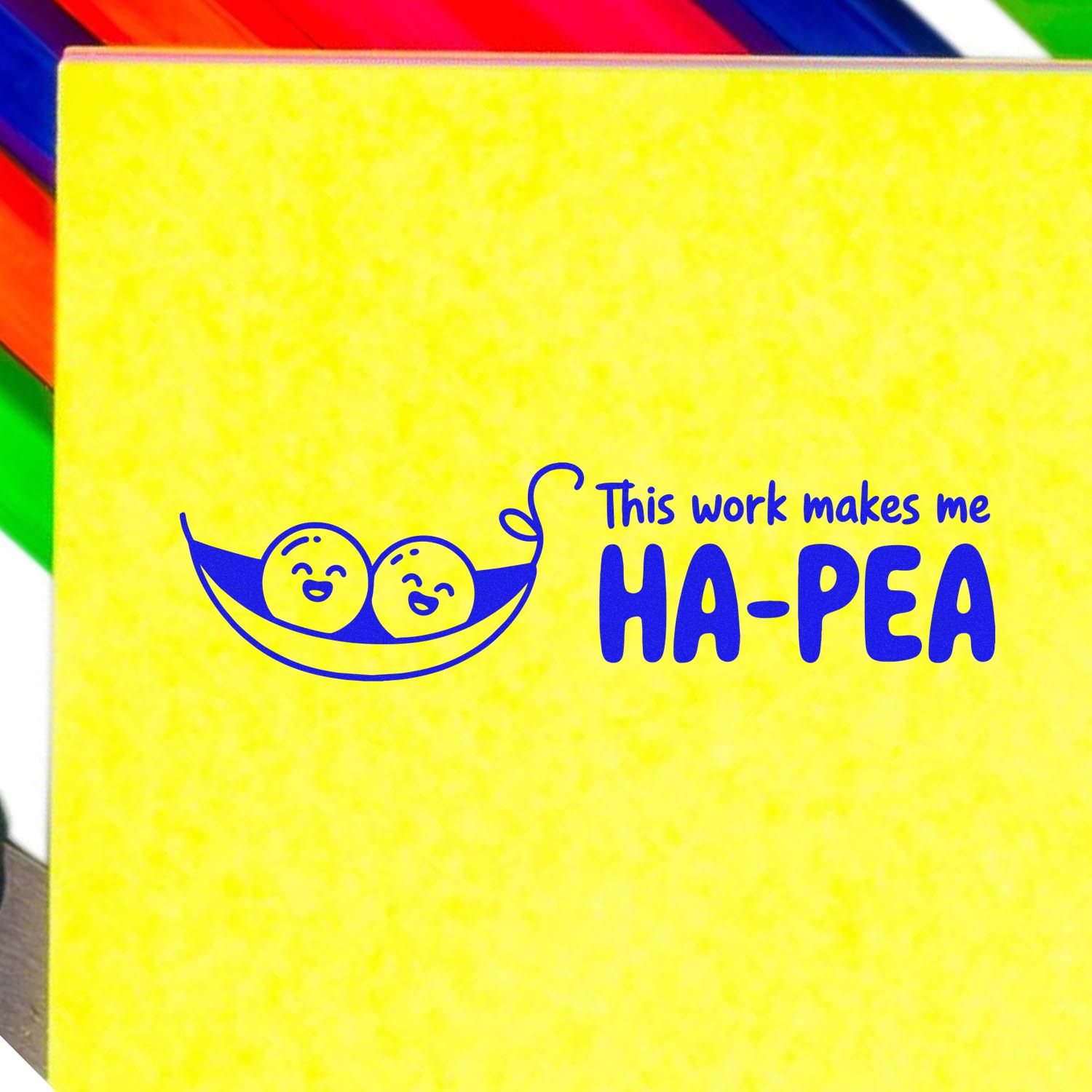 Yellow stamp seal with blue smiling pea-pod graphic and This work makes me HA-PEA text, with rainbow stripes.