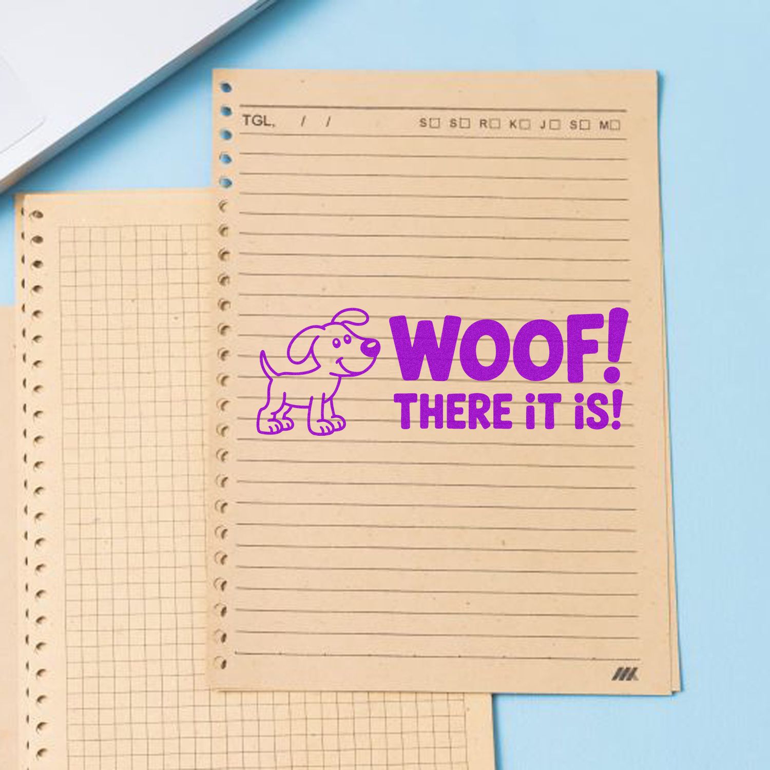 Purple dog stamp/seal reading WOOF! THERE IT IS! on beige lined notebook paper against a light blue background.