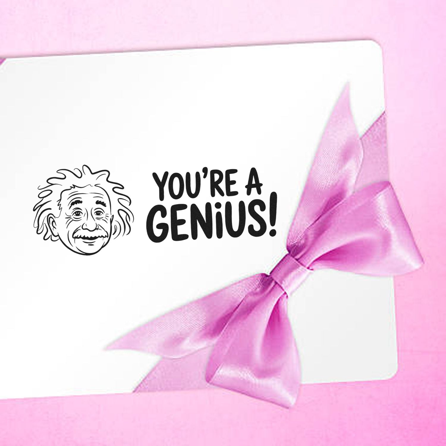Pink ribbon gift package with Einstein stamp seal and bold Youre a Genius! text on a white card.