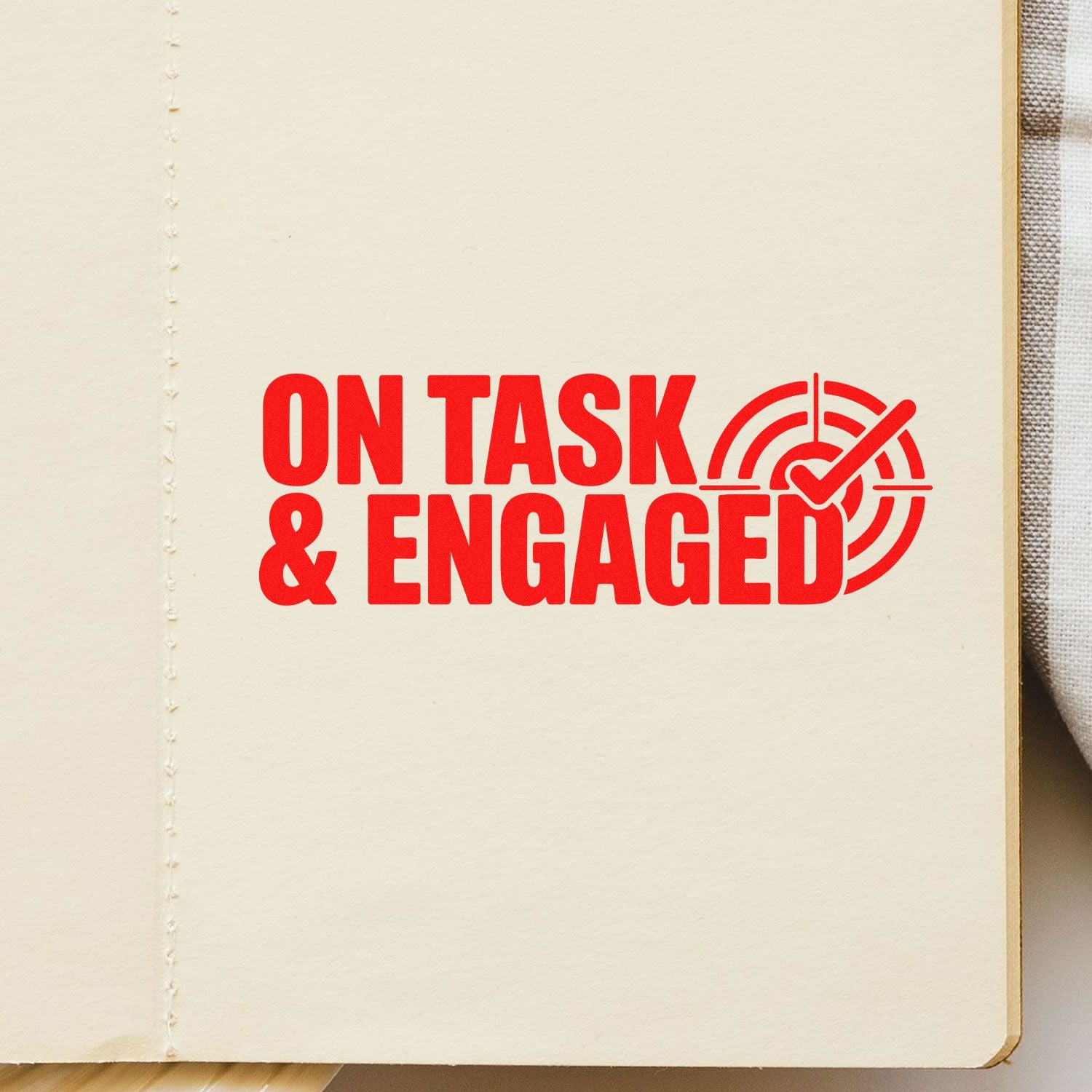 Cream page with red ON TASK & ENGAGED stamp and circular checkmark seal icon.