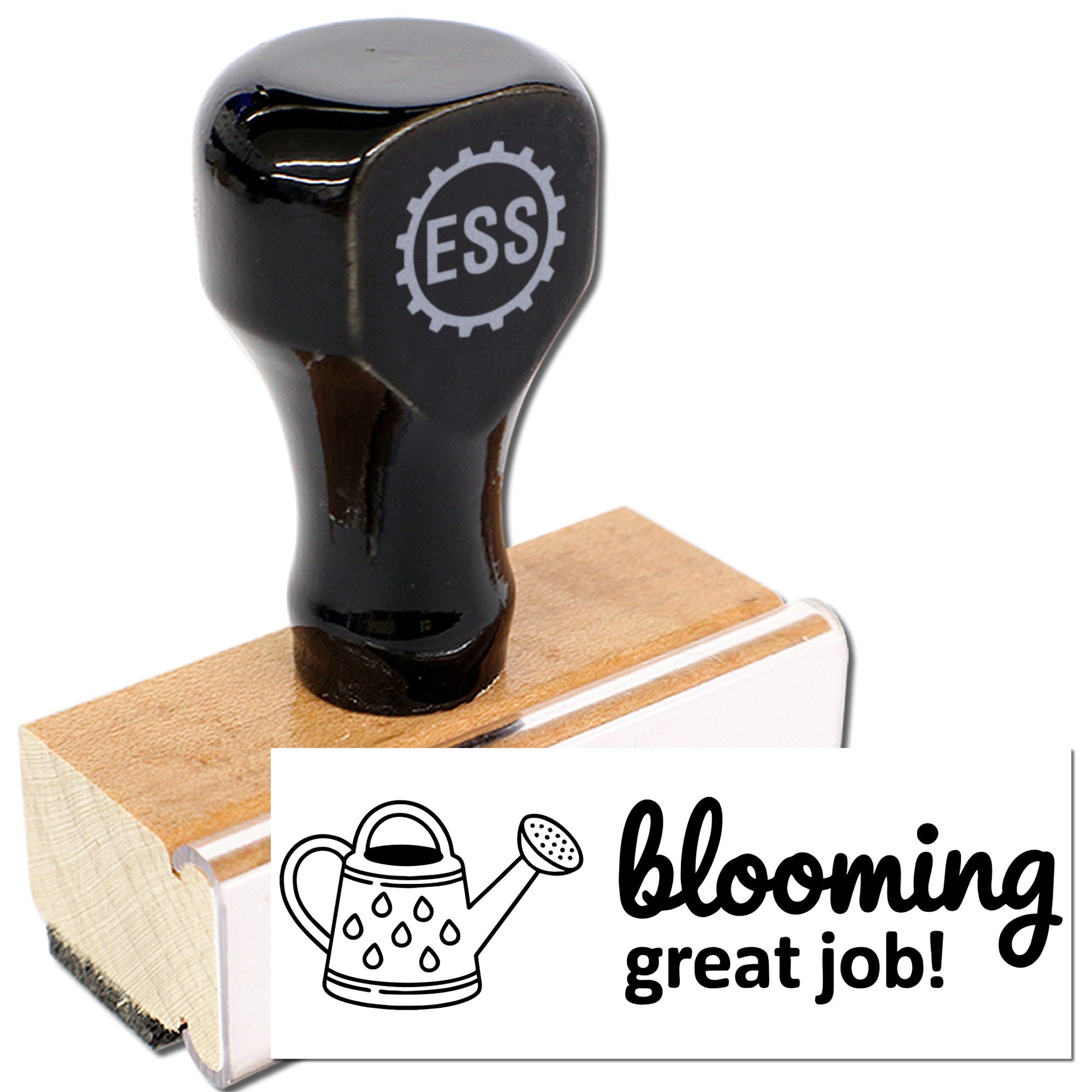 Black rubber stamp on wooden block with ESS logo, showing a white seal reading blooming great job! and watering can icon.