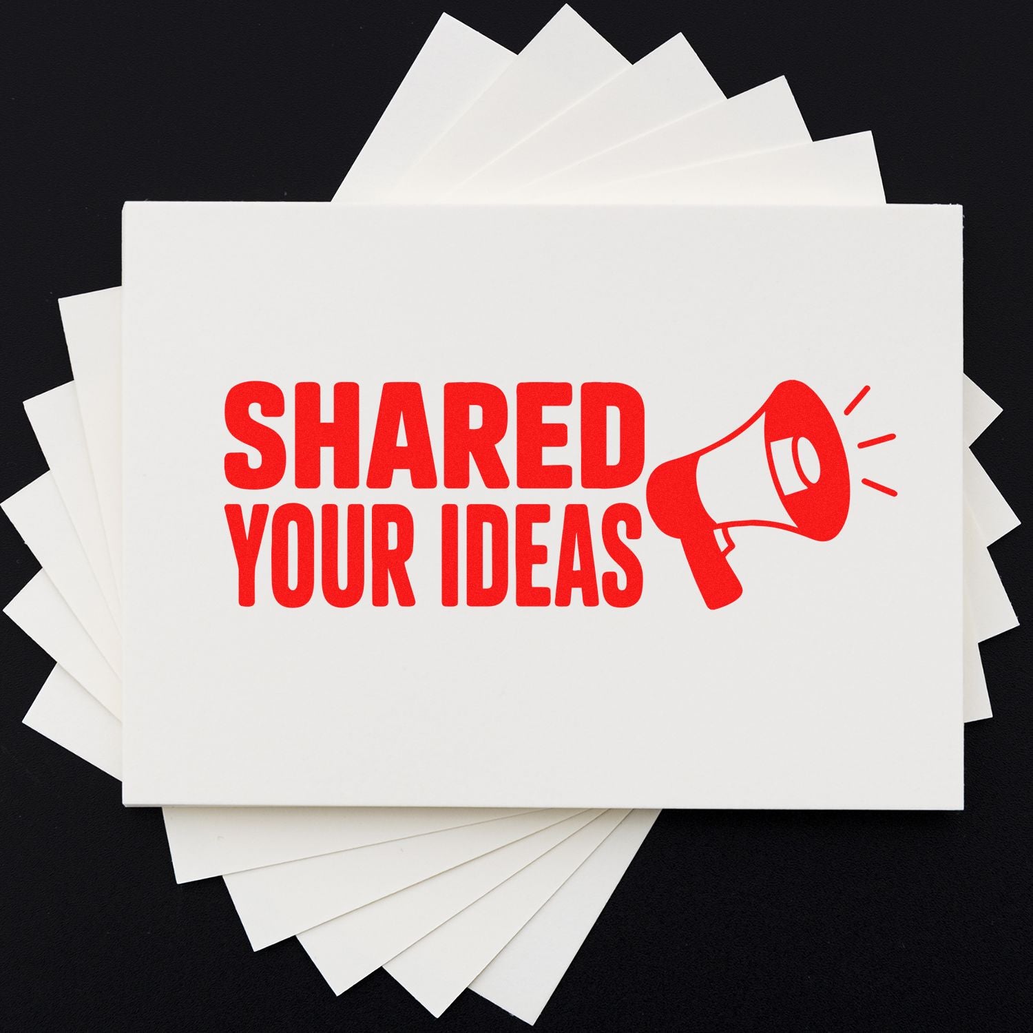 White stamp and seal cards with bold red SHARED YOUR IDEAS and megaphone on black background.