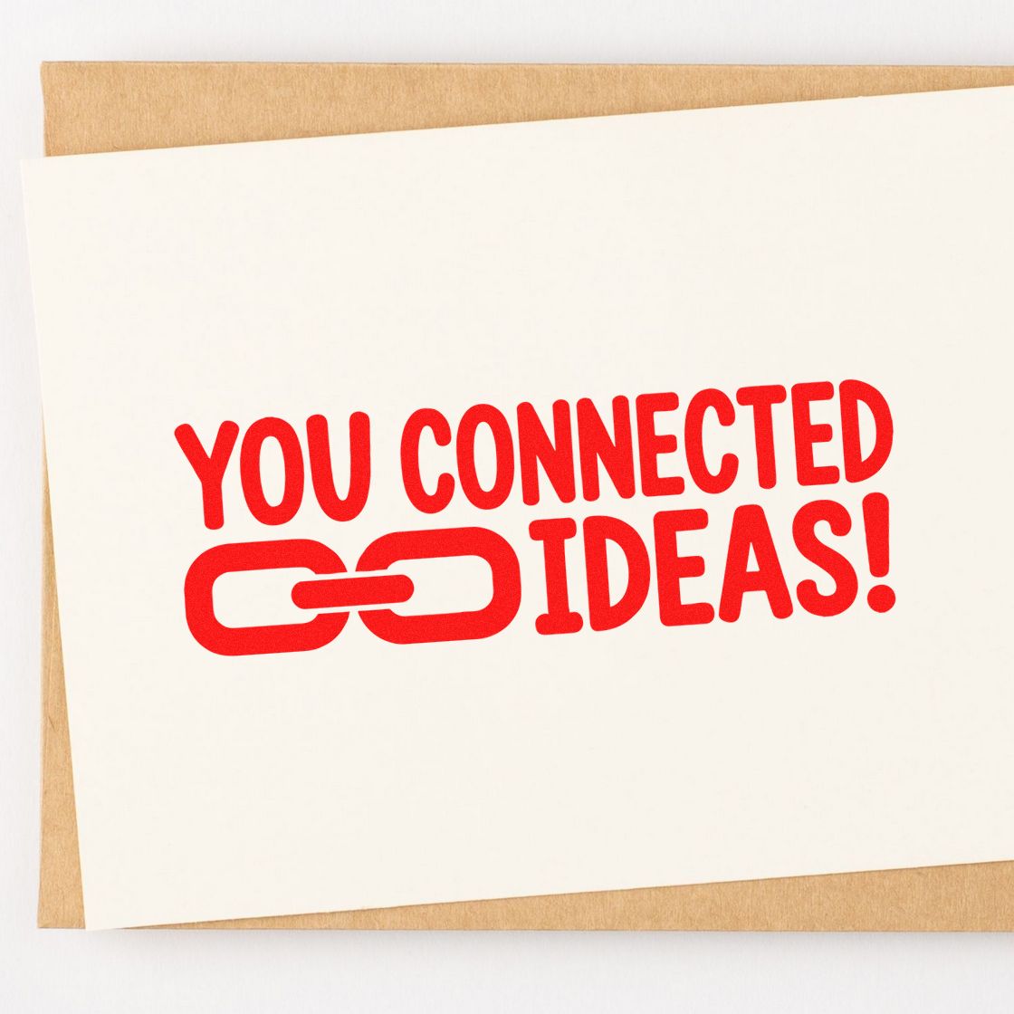 Custom red stamp seal reading You connected ideas! with chain-link icon on a white card over tan background.