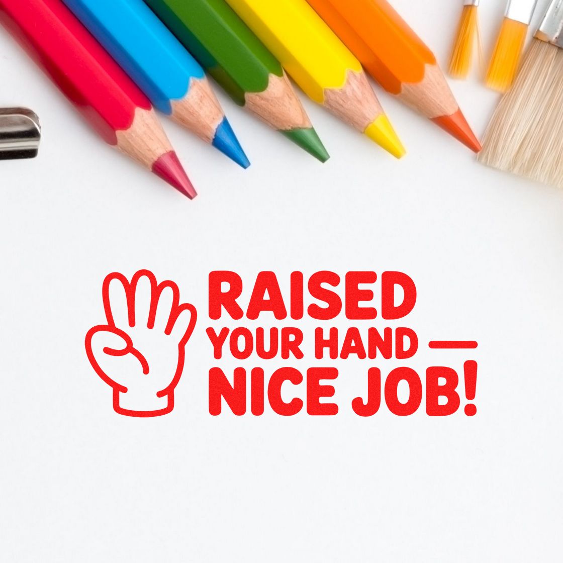 Red raised-hand stamp and seal with Nice Job! beside colorful pencils on a white background.