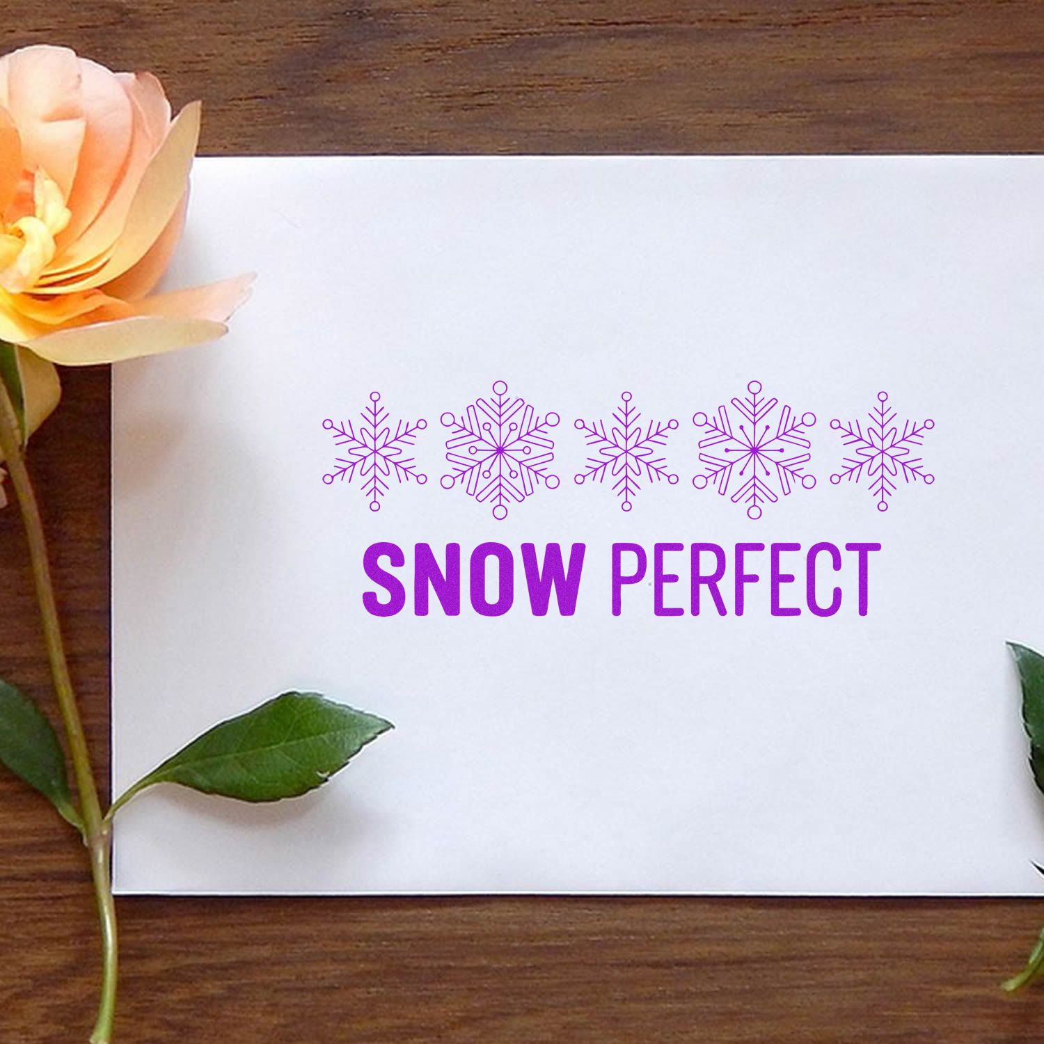 Purple snowflake stamp and seal print with SNOW PERFECT on white card and floral accents.