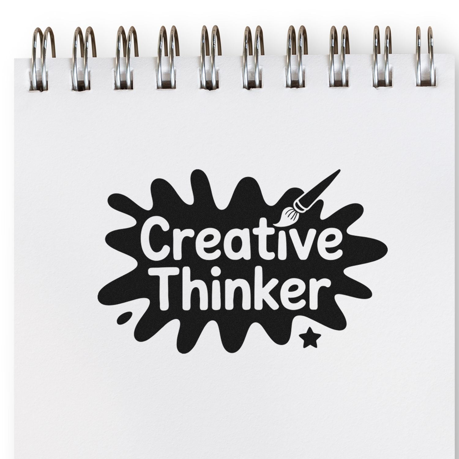 Black Creative Thinker stamp seal on a white spiral notebook page, with a paintbrush icon and star.