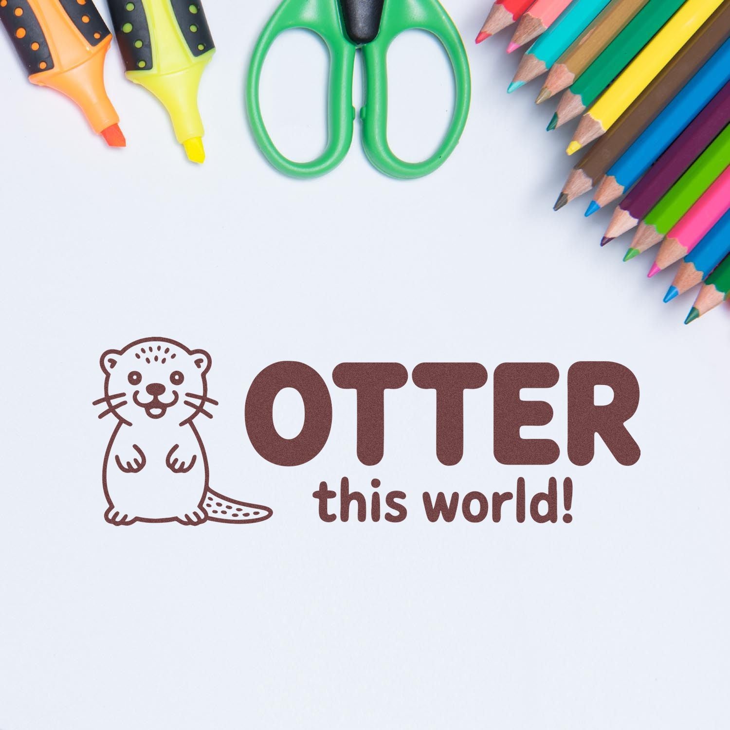 Brown otter-themed stamp and seal reading OTTER this world! with colorful pencils, scissors, and highlighters on white.