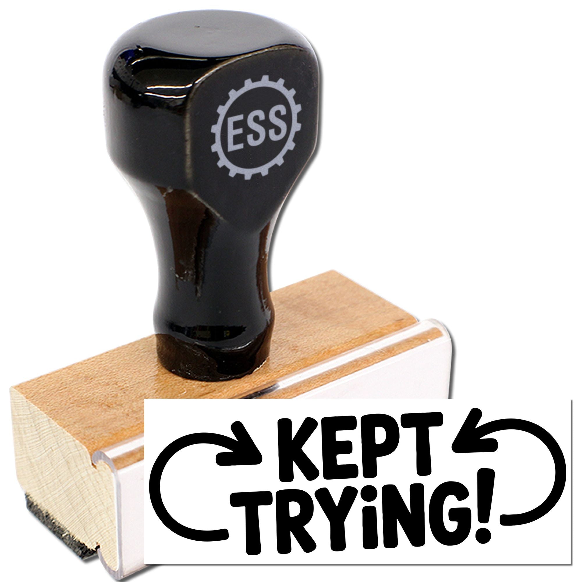 Black rubber stamp and seal on wooden base, featuring ESS logo and bold KEPT TRYING! impression.