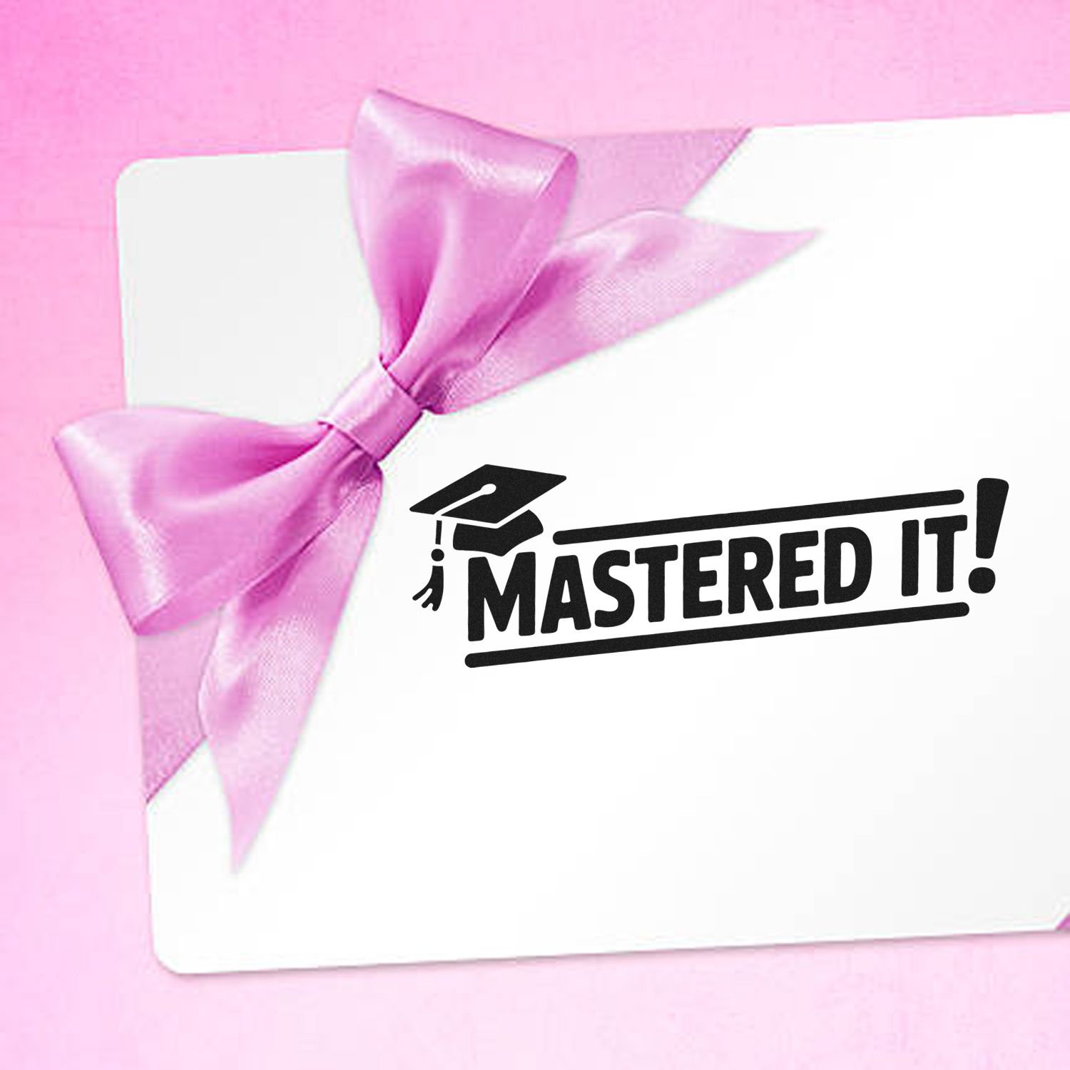 White card with pink satin bow and black Mastered It! stamp seal on a soft pink background.