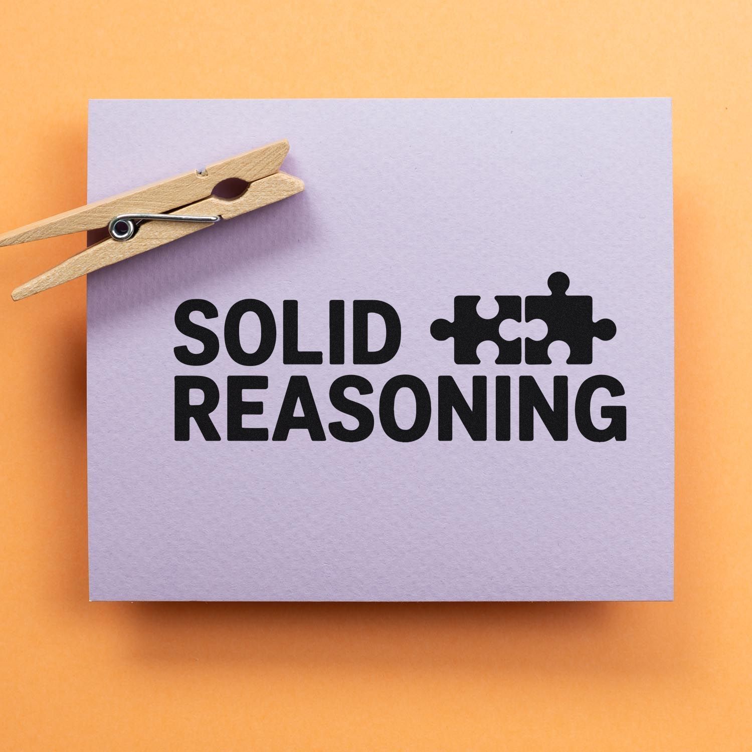 Lavender stamp and seal product card with black SOLID REASONING text, puzzle icon, and wooden clothespin on orange background.