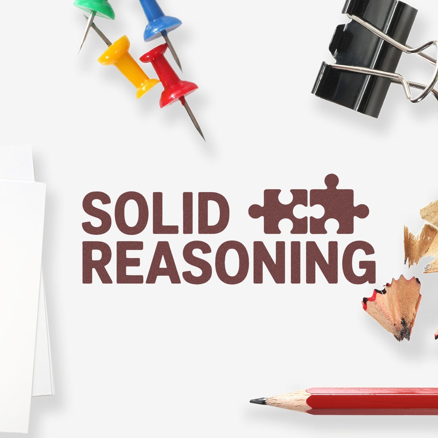 Solid Reasoning stamp design with brown text, puzzle pieces, colorful push pins, black binder clip, and red pencil.