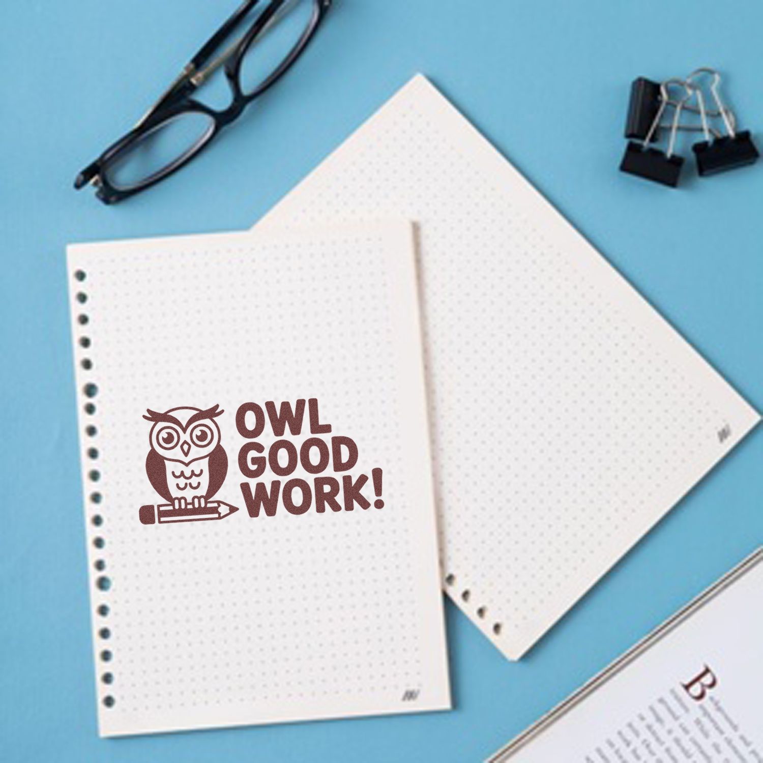Brown owl OWL GOOD WORK! rubber stamp on white dotted notebook pages, with blue background, glasses and binder clips.
