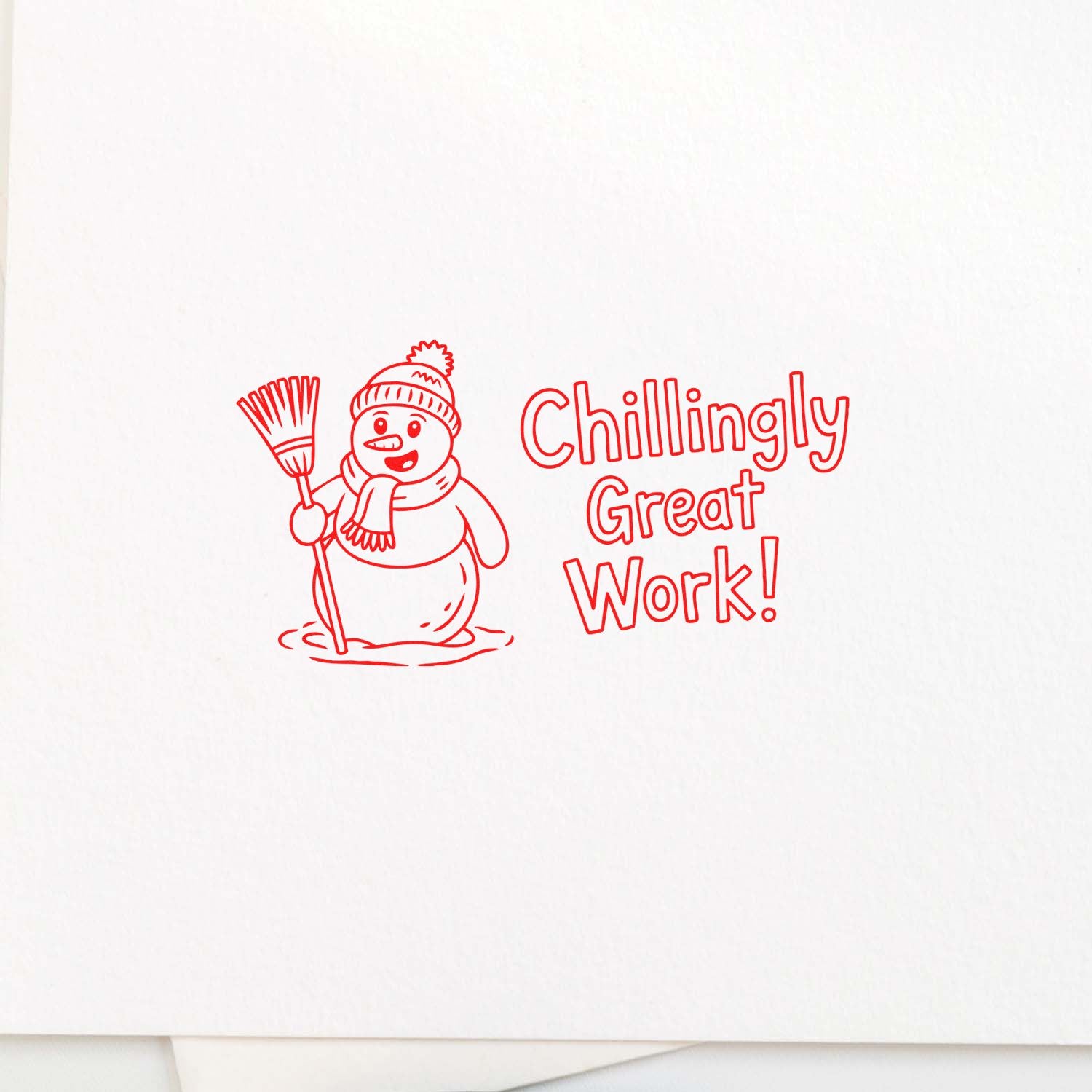 Red self-inking stamp seal with snowman holding broom and Chillingly Great Work! text on white background.
