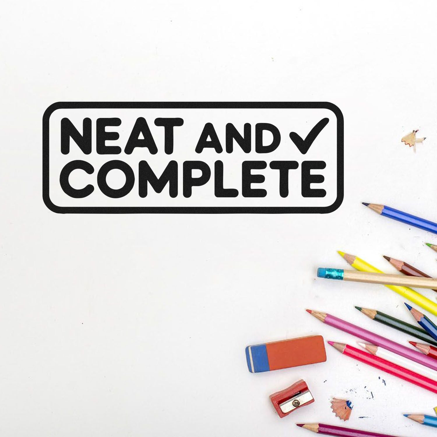 Neat and Complete rubber stamp with checkmark, surrounded by colorful pencils, eraser, and sharpener on white background.