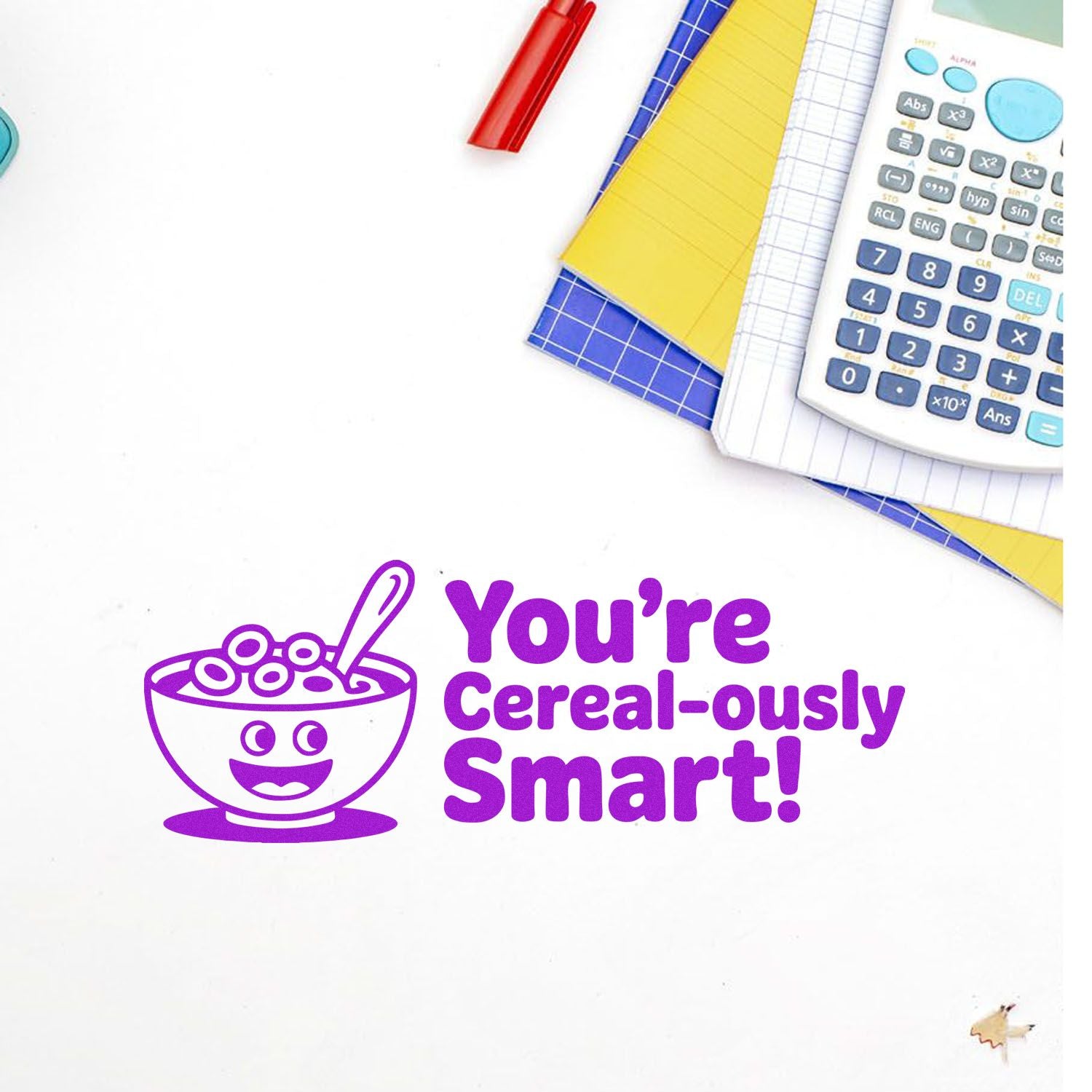 Purple self-inking stamp with cereal bowl icon and Youre Cereal-ously Smart! text beside notebooks and calculator