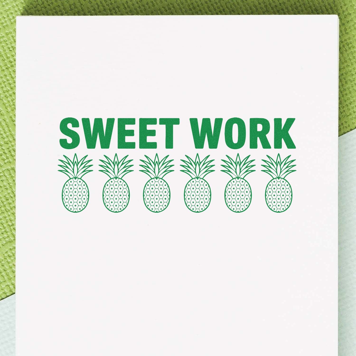 Green SWEET WORK stamp with six pineapple seal icons on a white card.