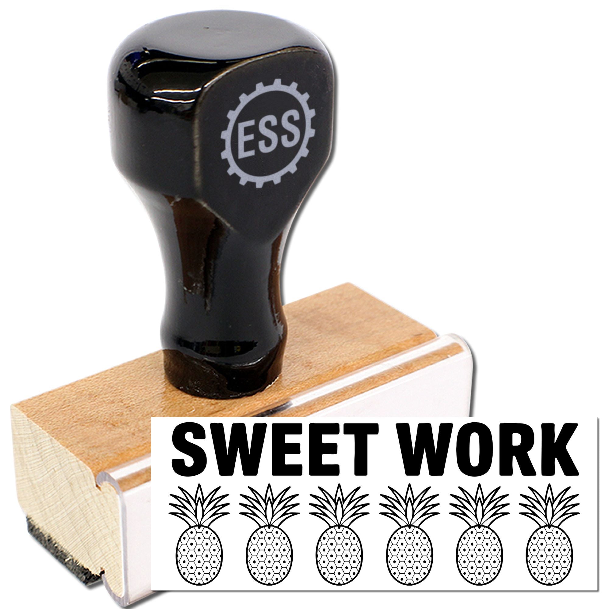 Black rubber stamp seal with ESS logo, on a wooden block, showing a Sweet Work pineapple design.