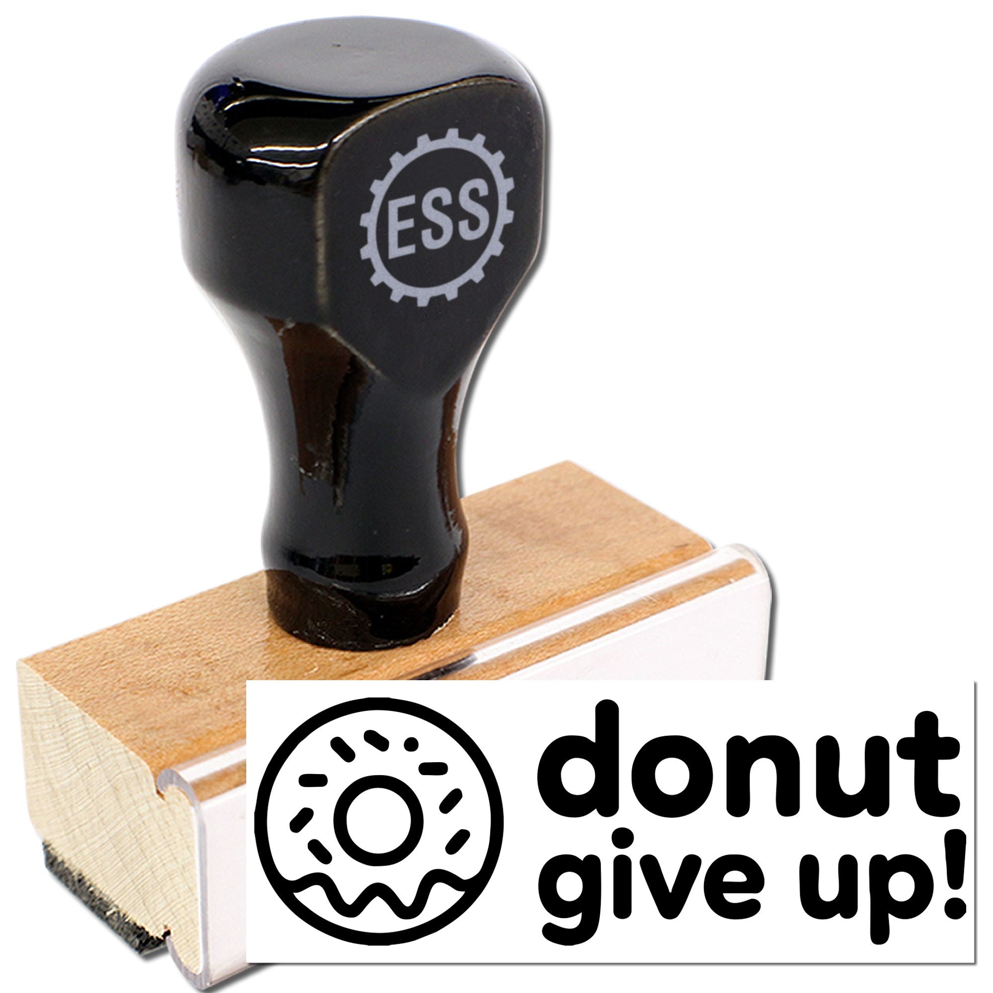 Black rubber stamp and seal with donut logo and bold donut give up! text on a wooden block, white background