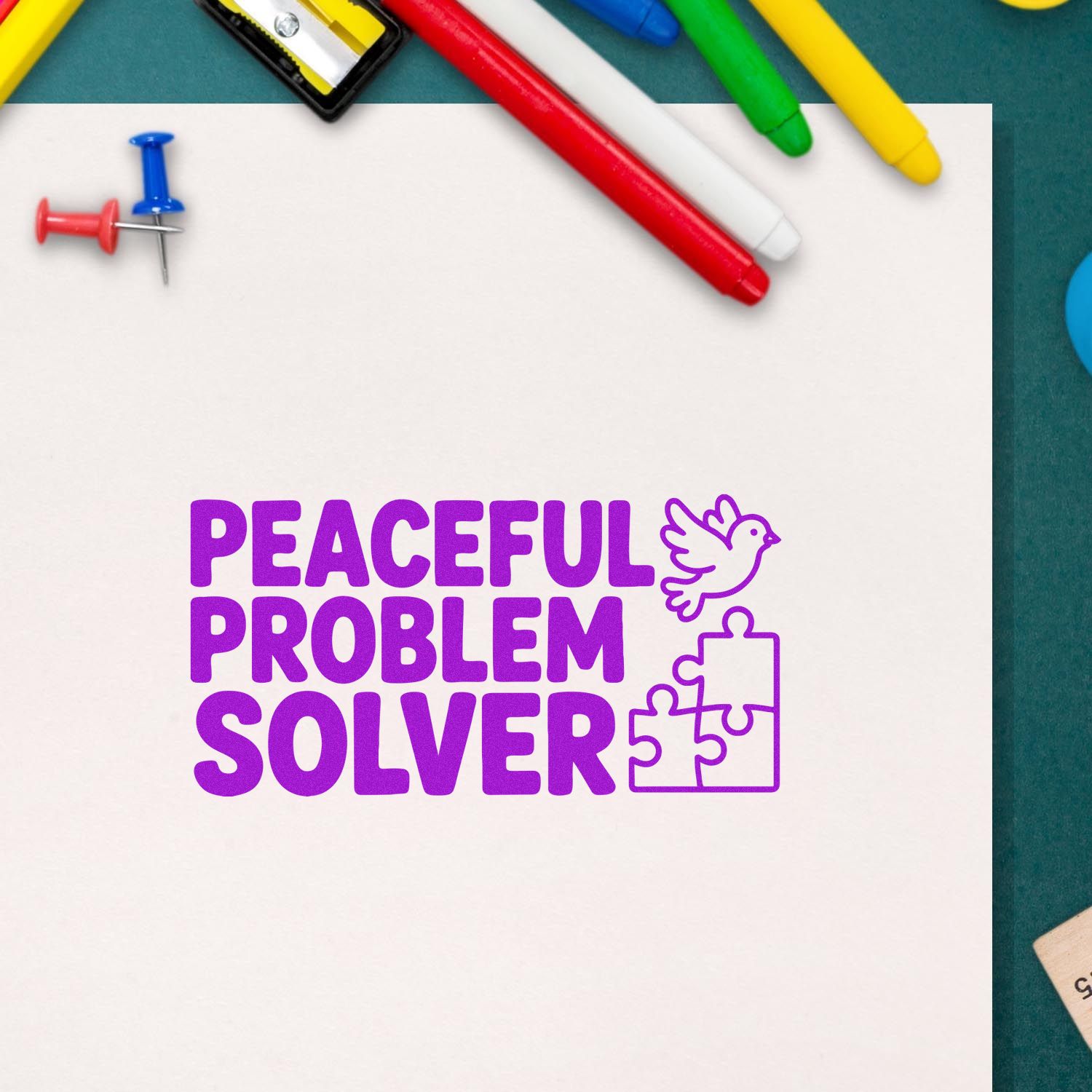Purple Peaceful Problem Solver stamp with dove and puzzle pieces on white paper, surrounded by colorful pens and pushpins