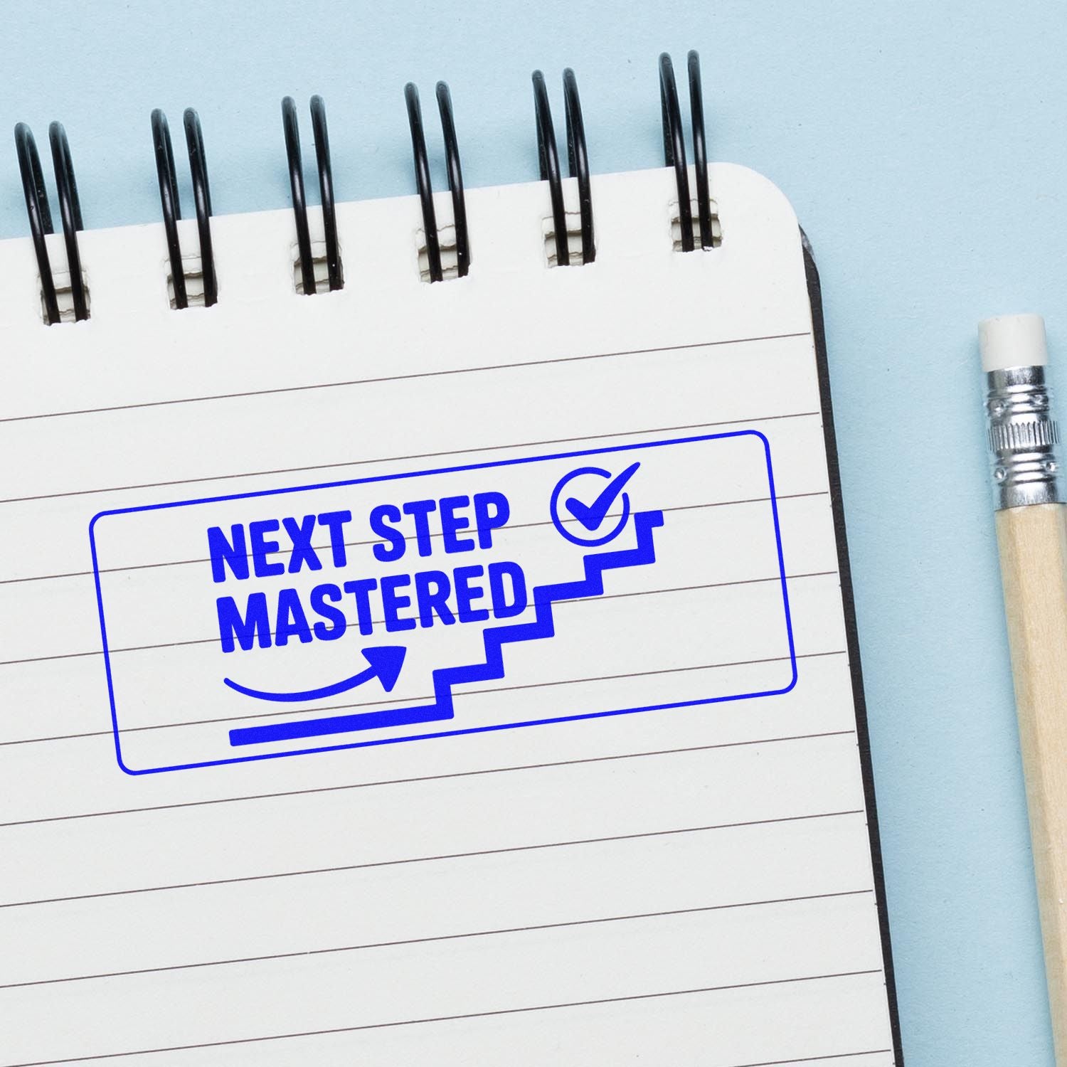 Blue rubber stamp seal reading NEXT STEP MASTERED on lined notepad, with checkmark and staircase icon.