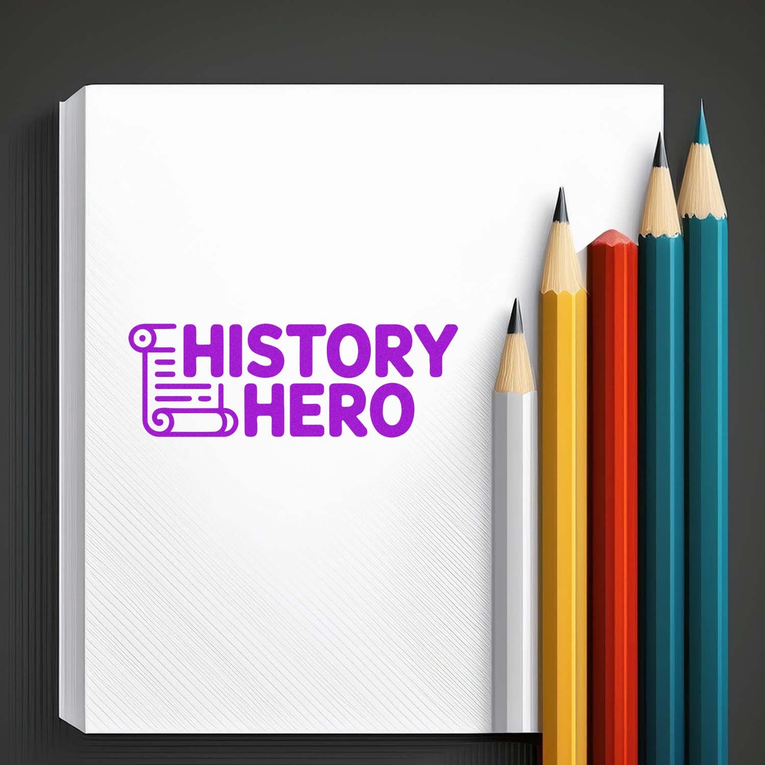 White stamp pad with purple HISTORY HERO seal beside yellow, red, teal, and blue pencils on a dark background.