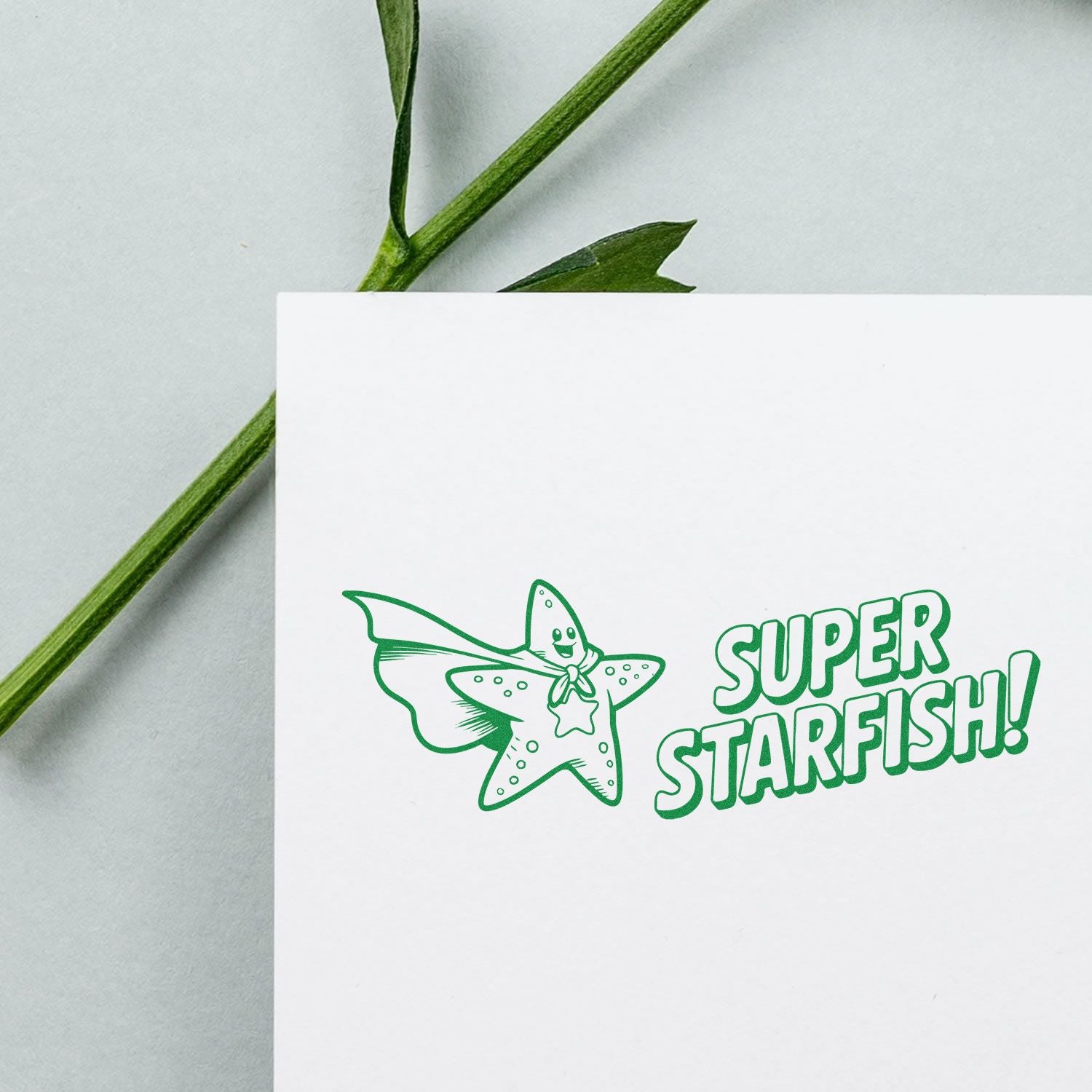 Green Super Starfish stamp and seal on white card, with a cartoon starfish illustration.