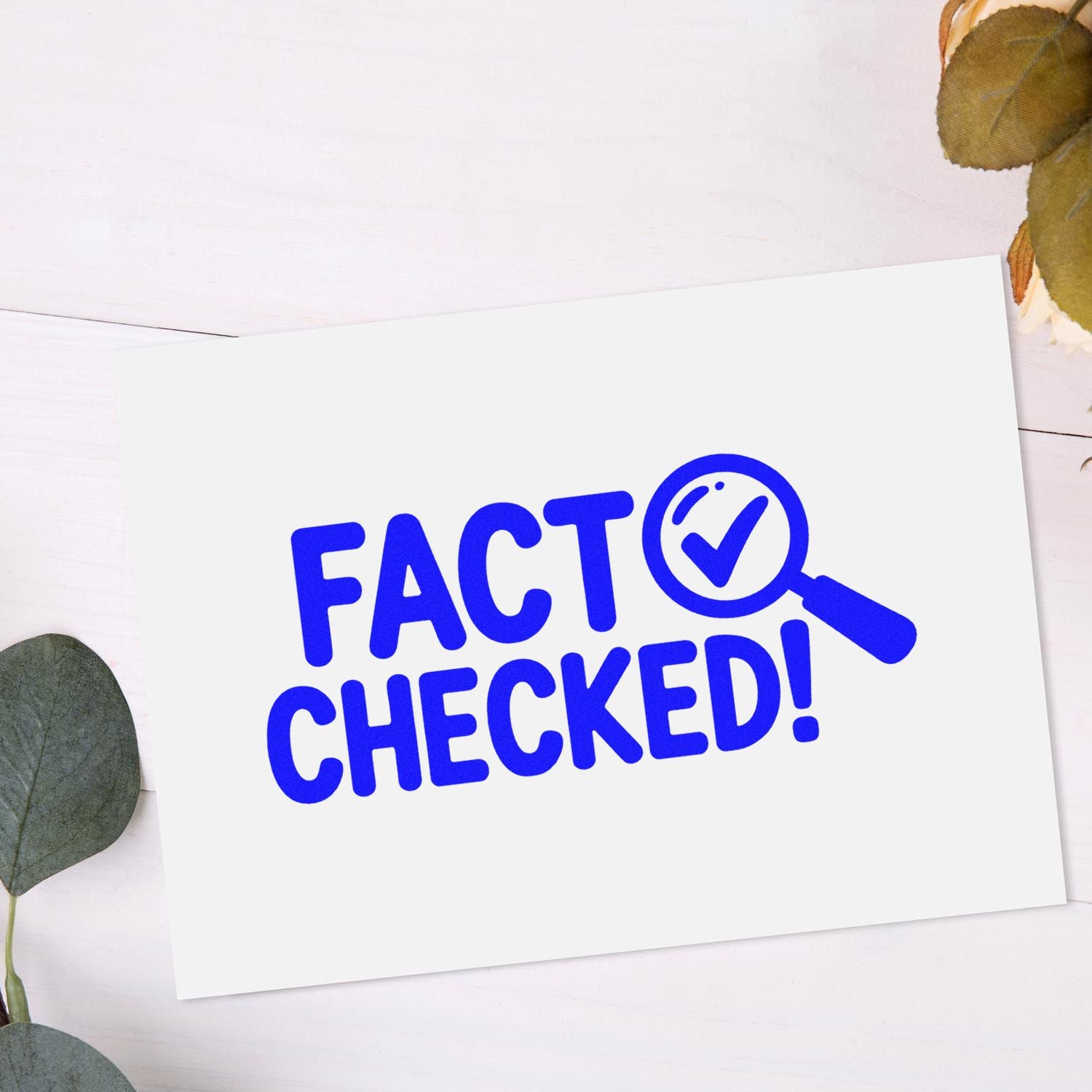 Blue FACT CHECKED stamp seal with magnifying glass checkmark on a white card.
