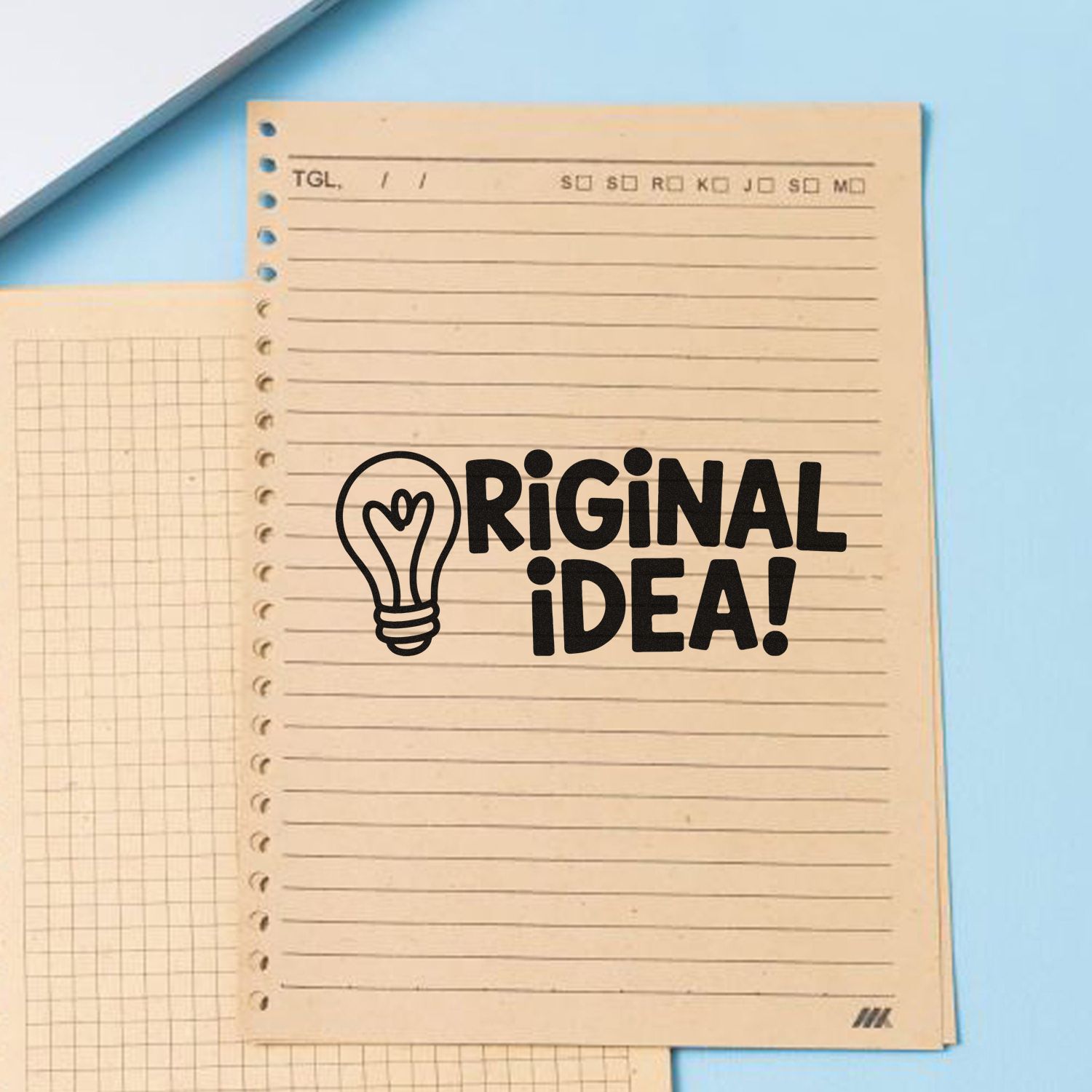 Beige lined notebook page with black Original Idea lightbulb stamp seal on a light blue background.