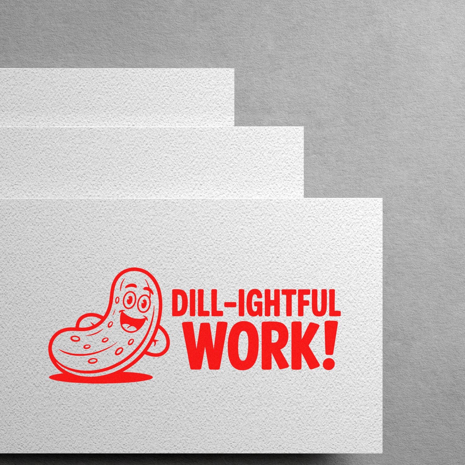 Red custom stamp and seal with smiling pickle and DILL-IGHTFUL WORK! on textured white paper.