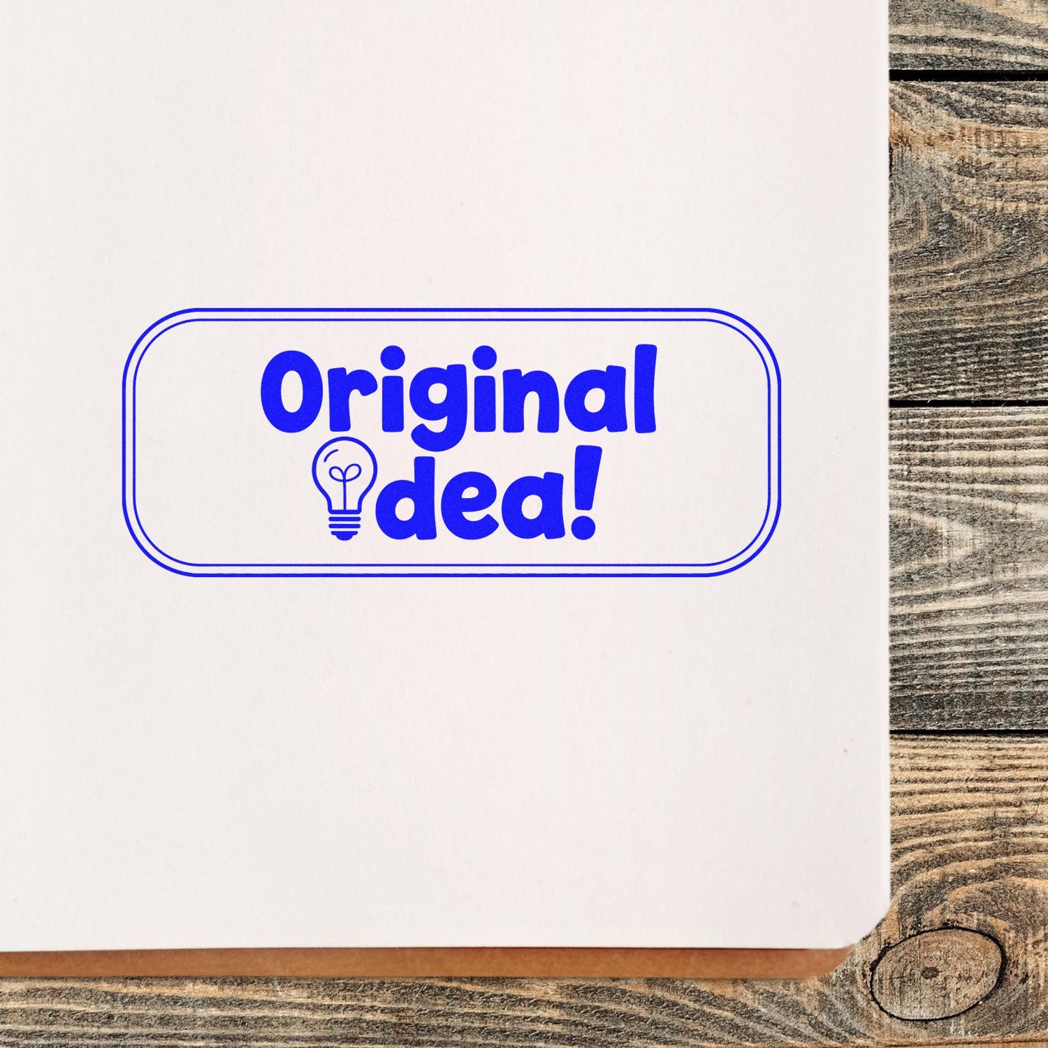 Blue Original idea! stamp seal with lightbulb icon on white paper over rustic wood background.