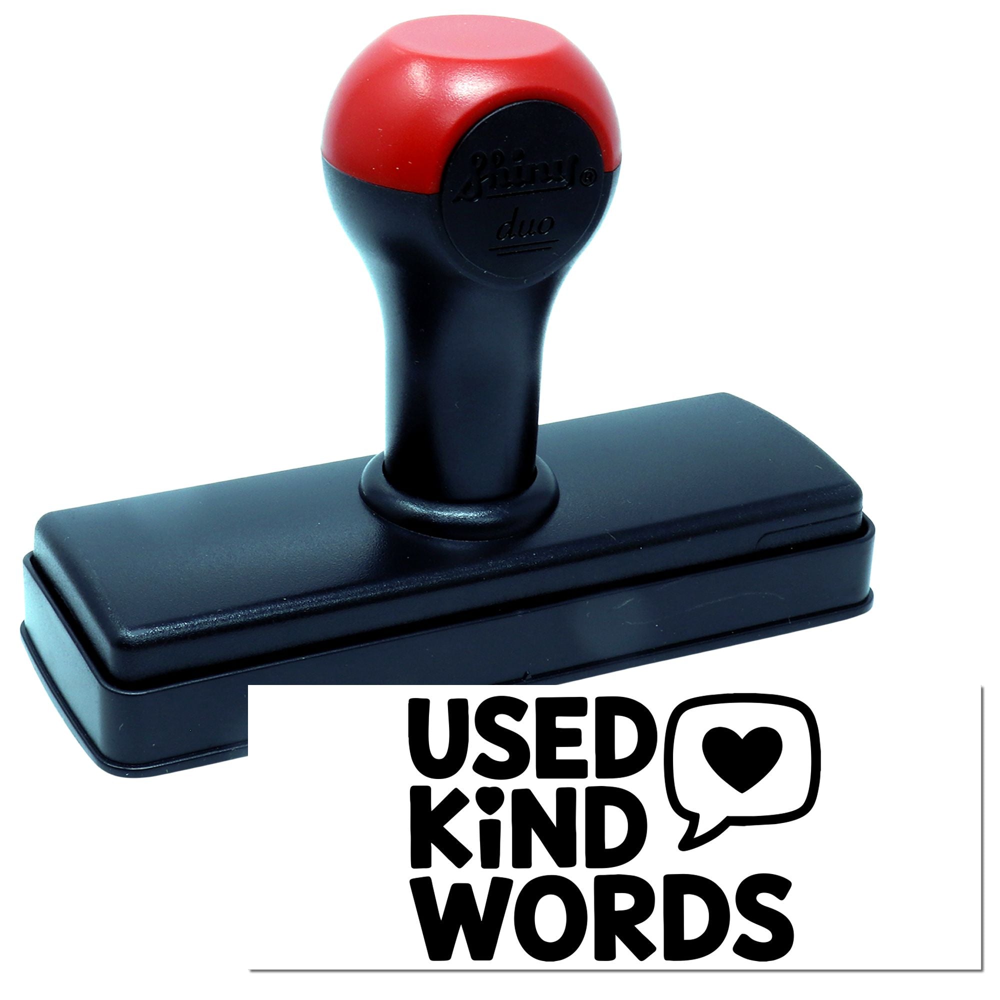 Red and black self-inking stamp and seal reading Used Kind Words with heart speech bubble.