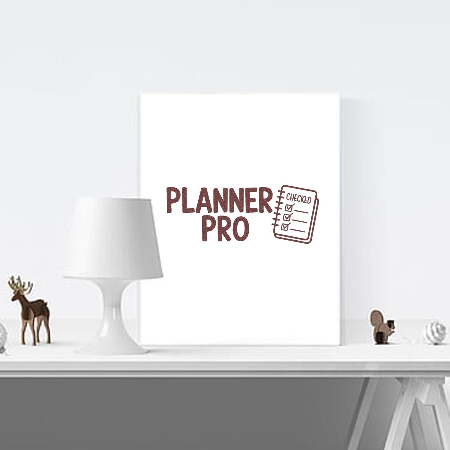 Brown PLANNER PRO checklist stamp and seal on a white notebook, with checked boxes and minimalist desk decor.