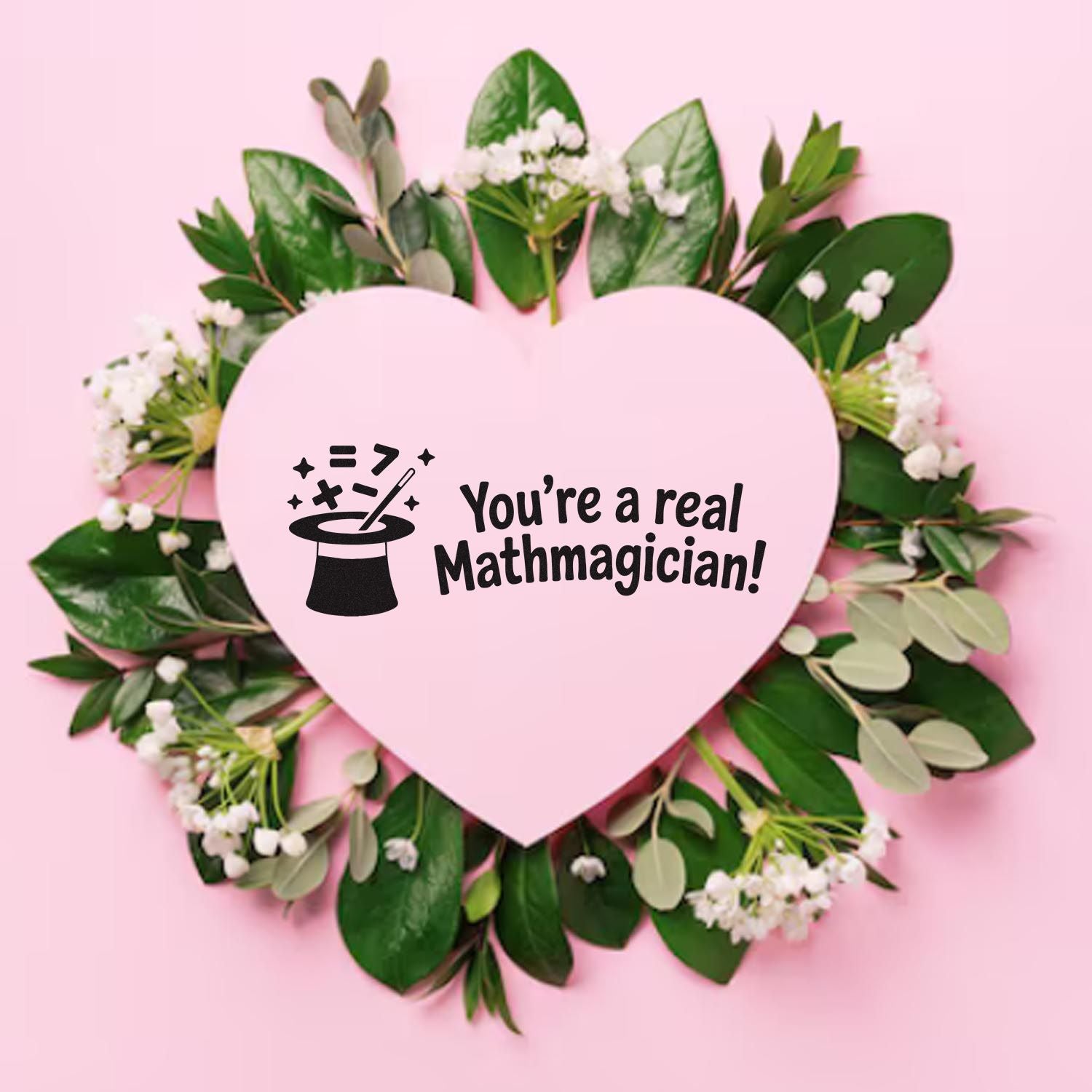 Pink heart stamp seal with black magic hat icon and Youre a real Mathmagician! text, framed by green leaves and white flowers.