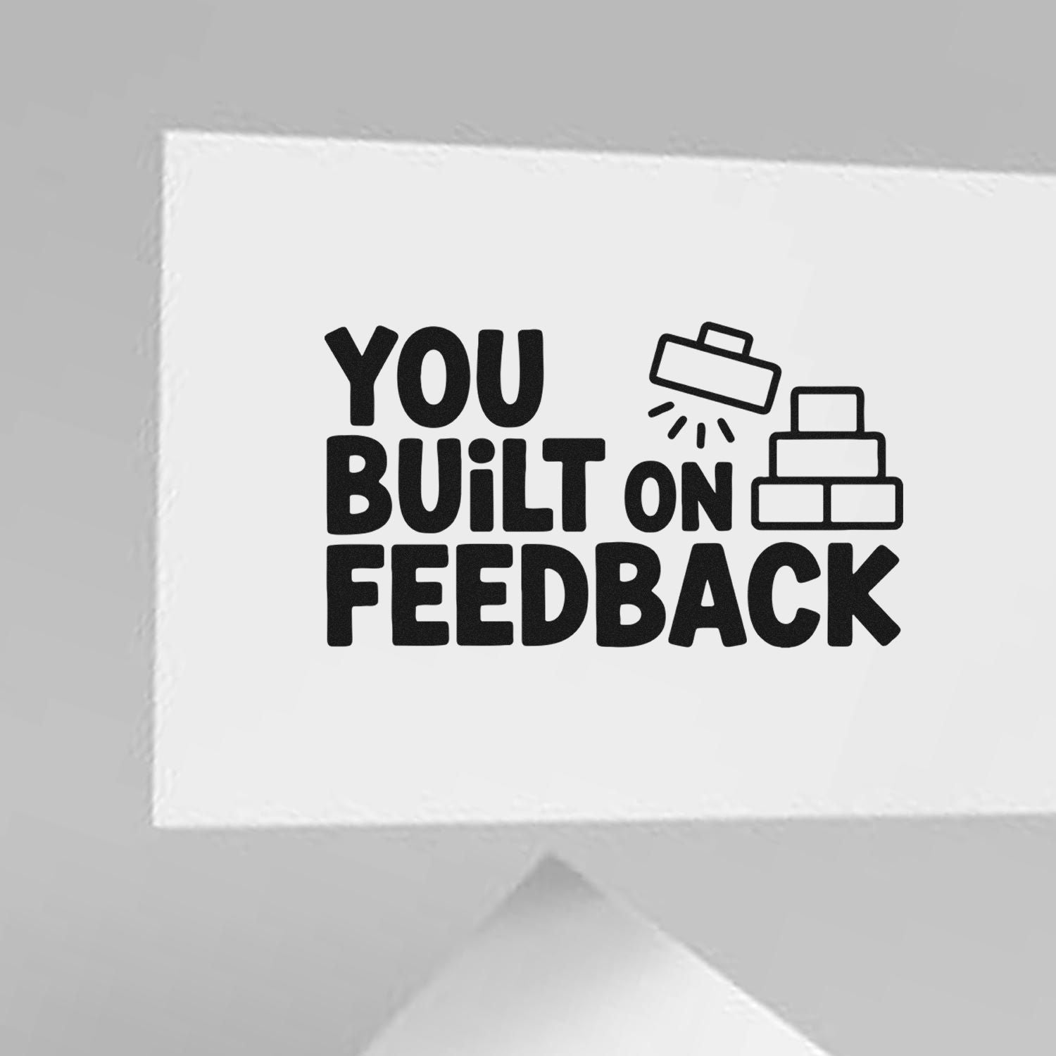 White stamp-and-seal card with black You Built on Feedback text and builder stamp icons.