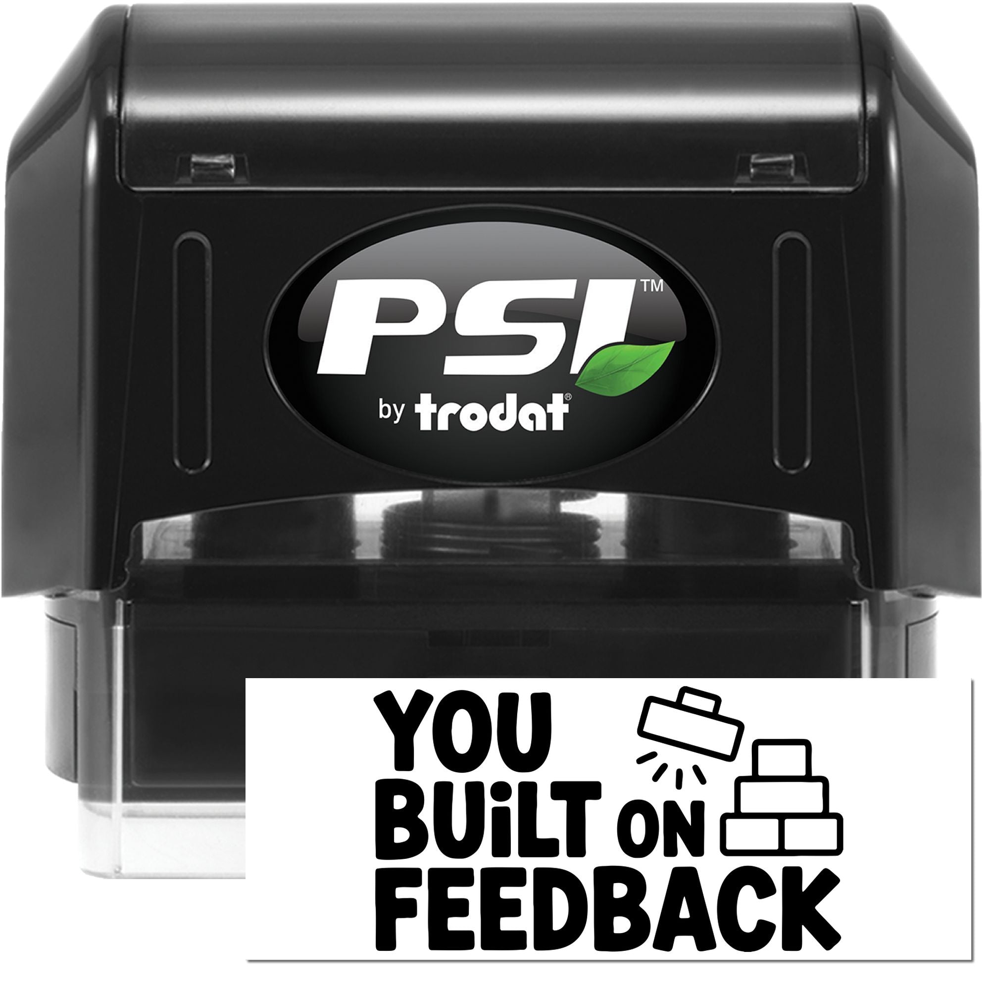Black PSI by Trodat self-inking stamp and seal, black case with green leaf logo and You Built on Feedback imprint.