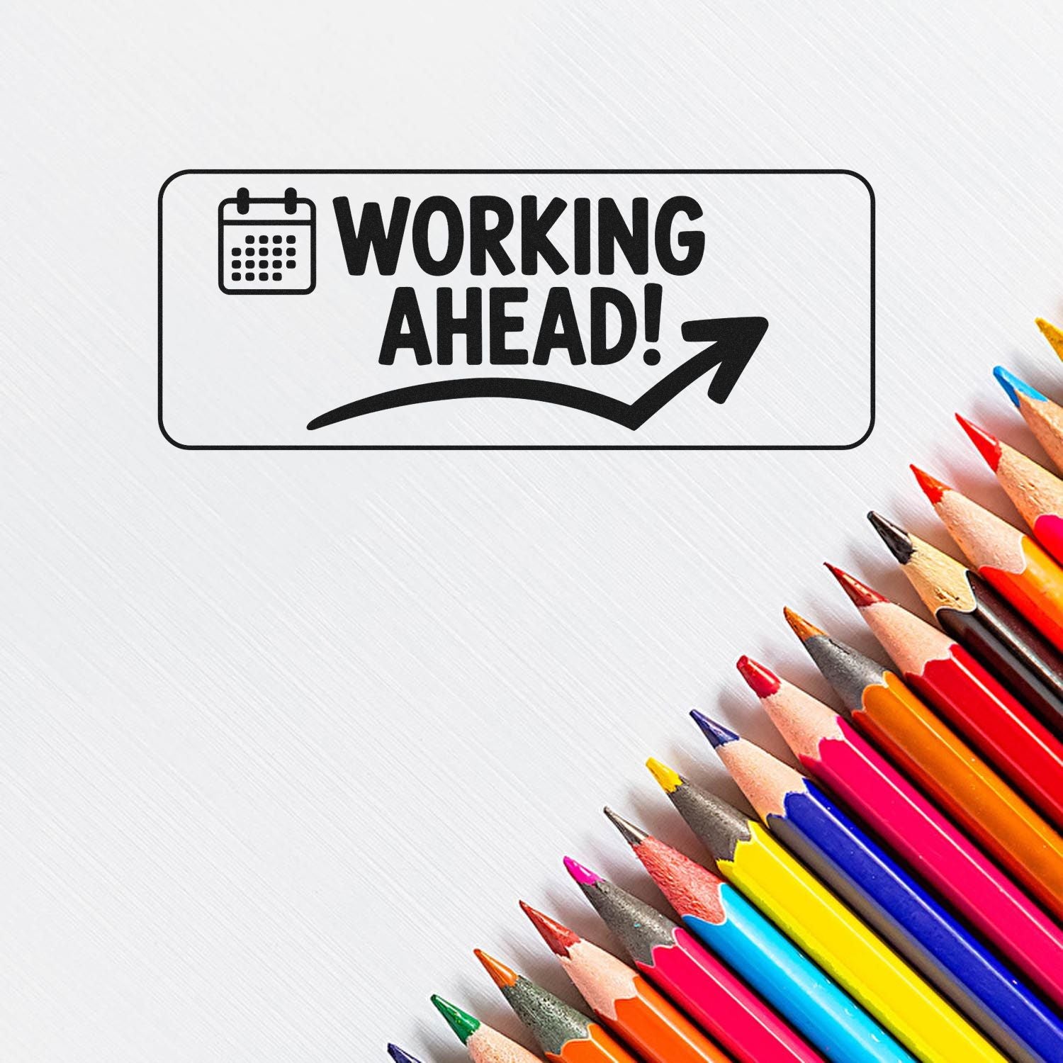 Black Working Ahead! rubber stamp seal with calendar icon and arrow on white background, beside colorful pencils.