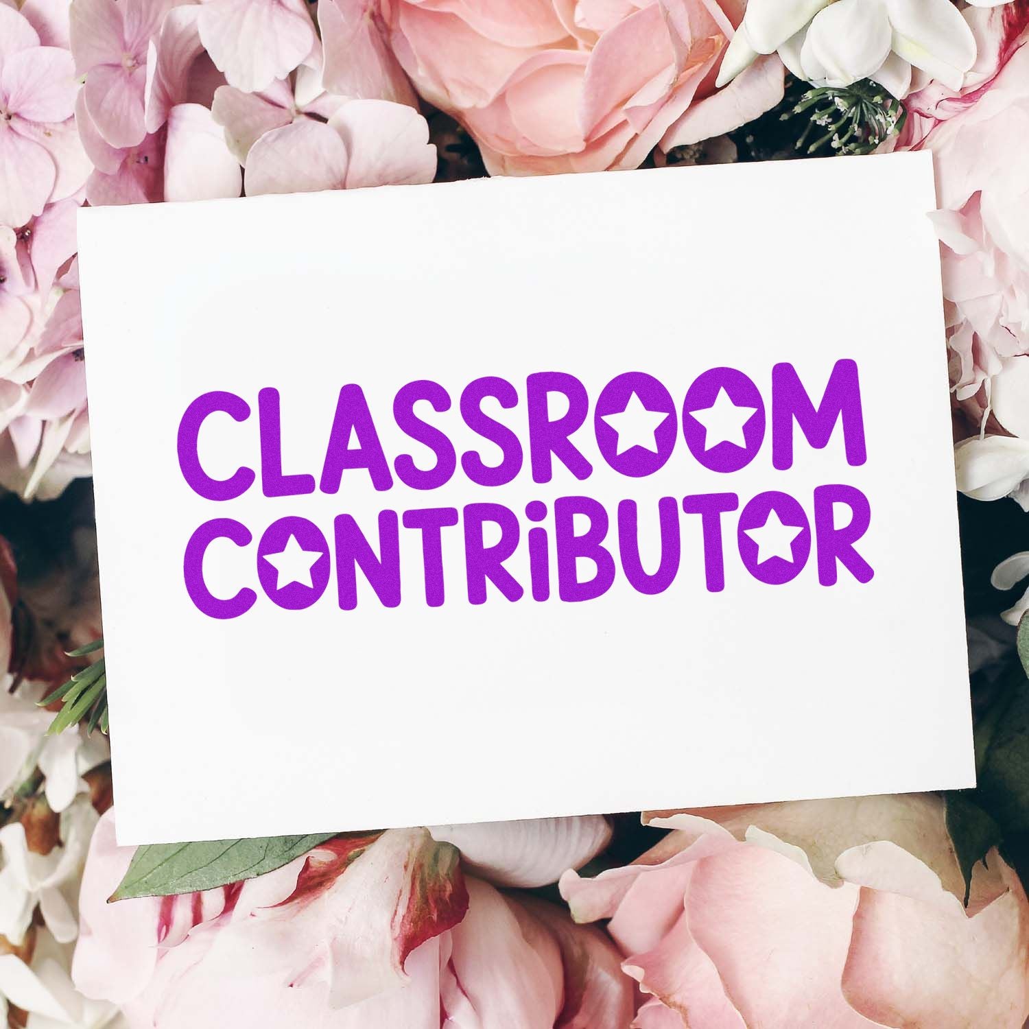 White stamp seal card with bold purple Classroom Contributor text and star cutouts on a pink floral background.