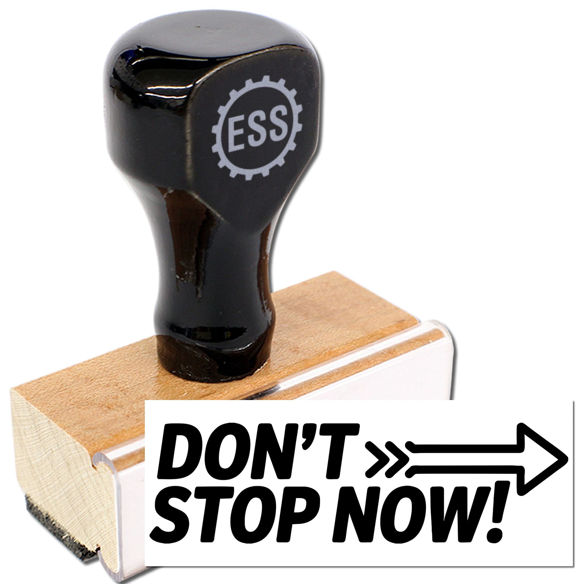 Black ESS rubber stamp on a wooden block with bold DONT STOP NOW! text and arrow graphic.