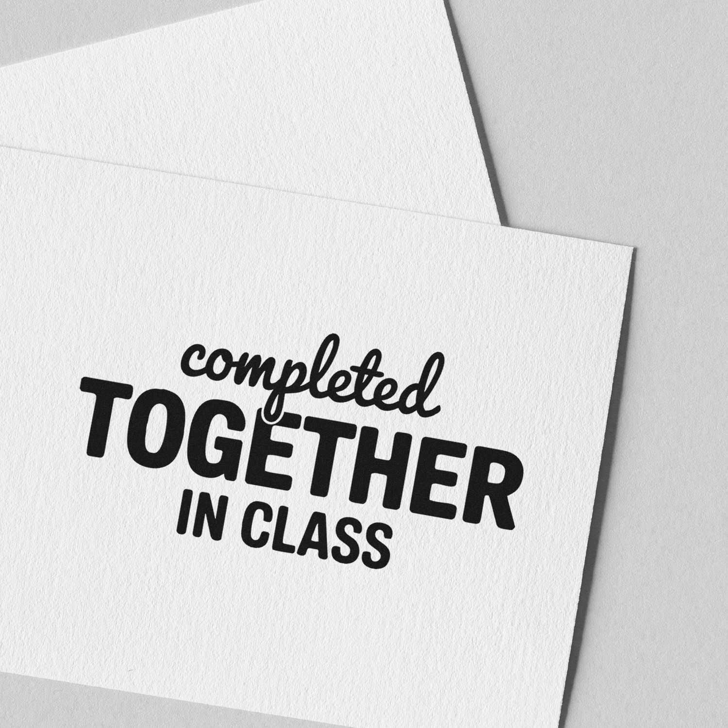 Black completed together in class rubber stamp seal on white textured paper with envelope.