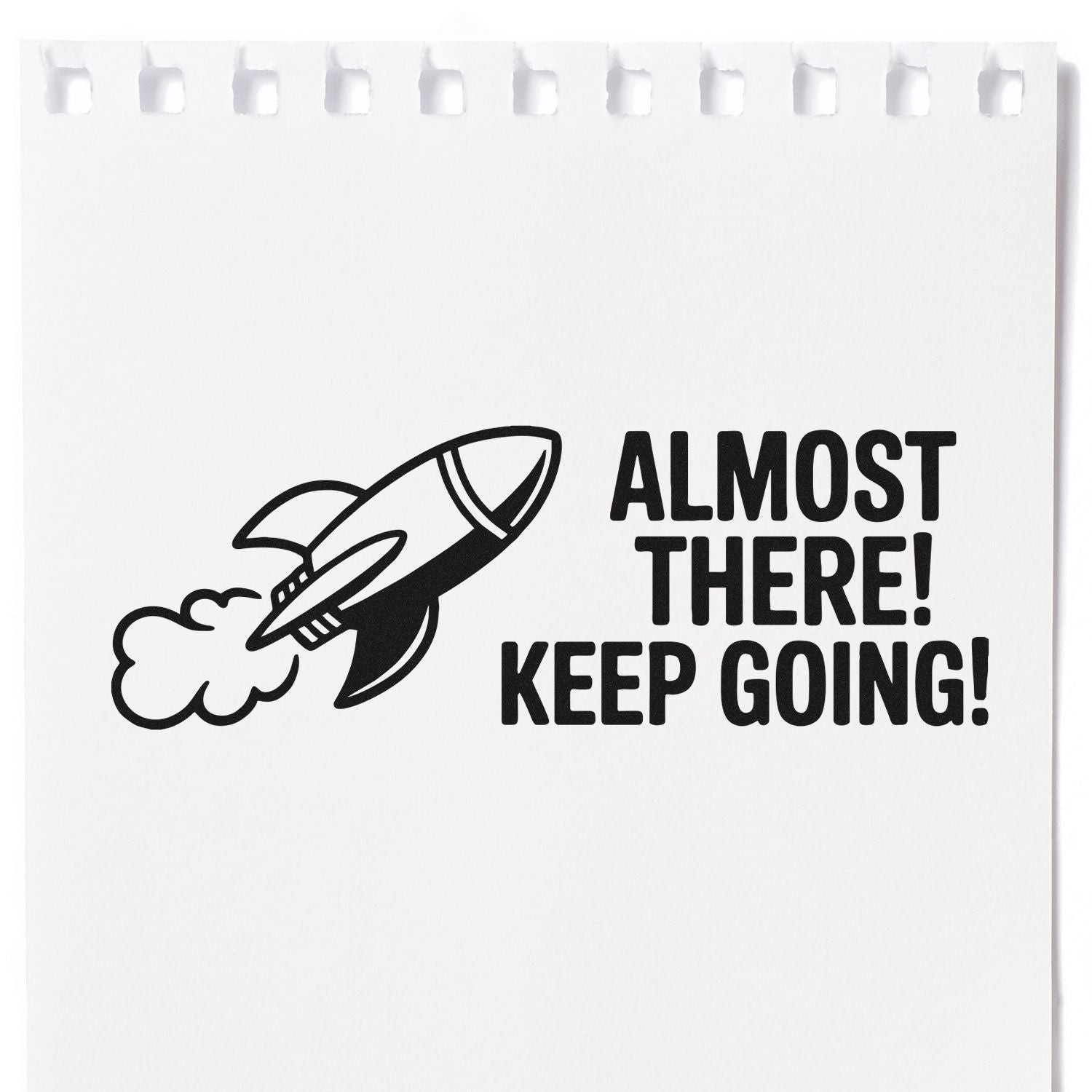 Black stamp and seal design on white paper with rocket and bold text: ALMOST THERE! KEEP GOING!