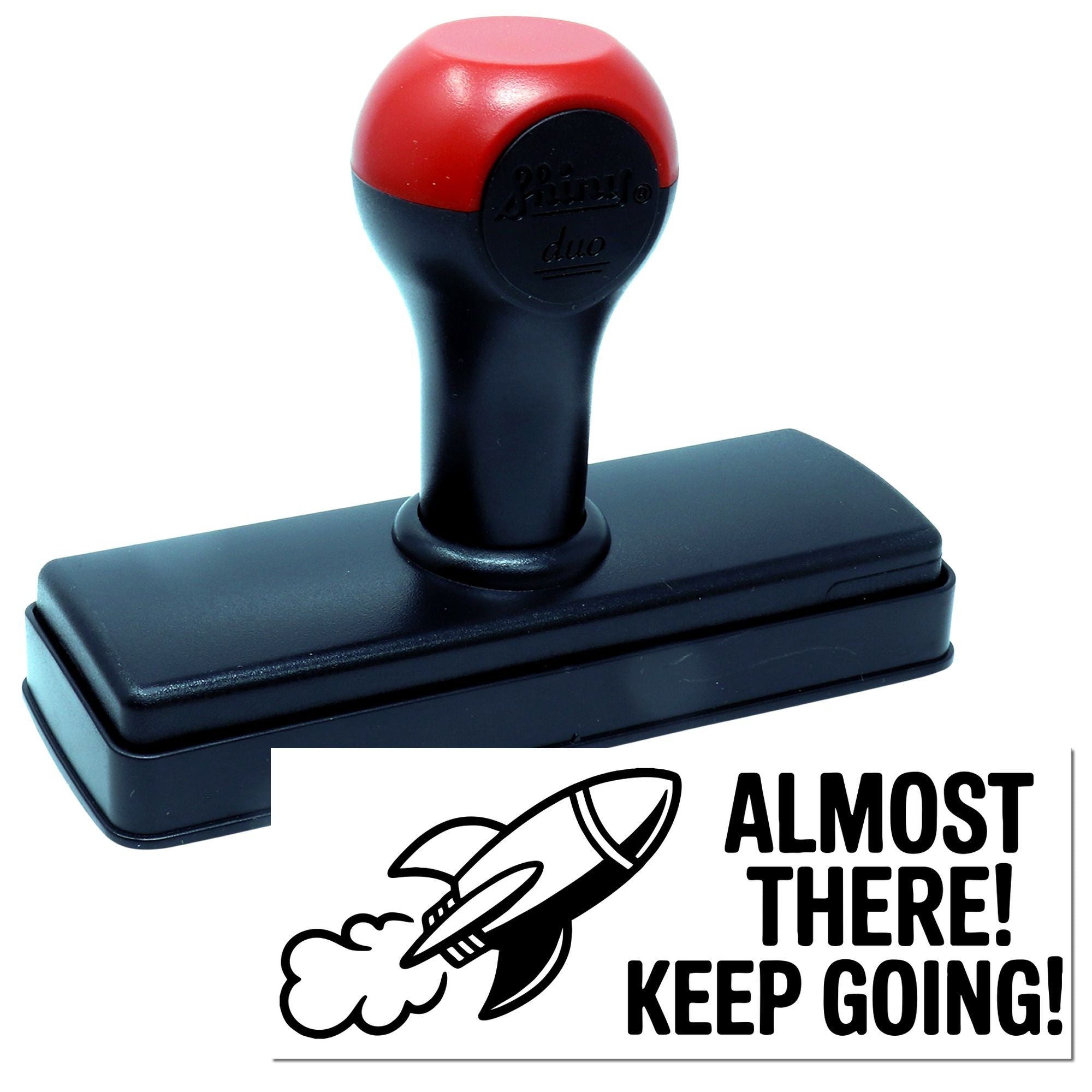 Red and black self-inking stamp and seal with rocket graphic and Almost There! Keep Going! text.